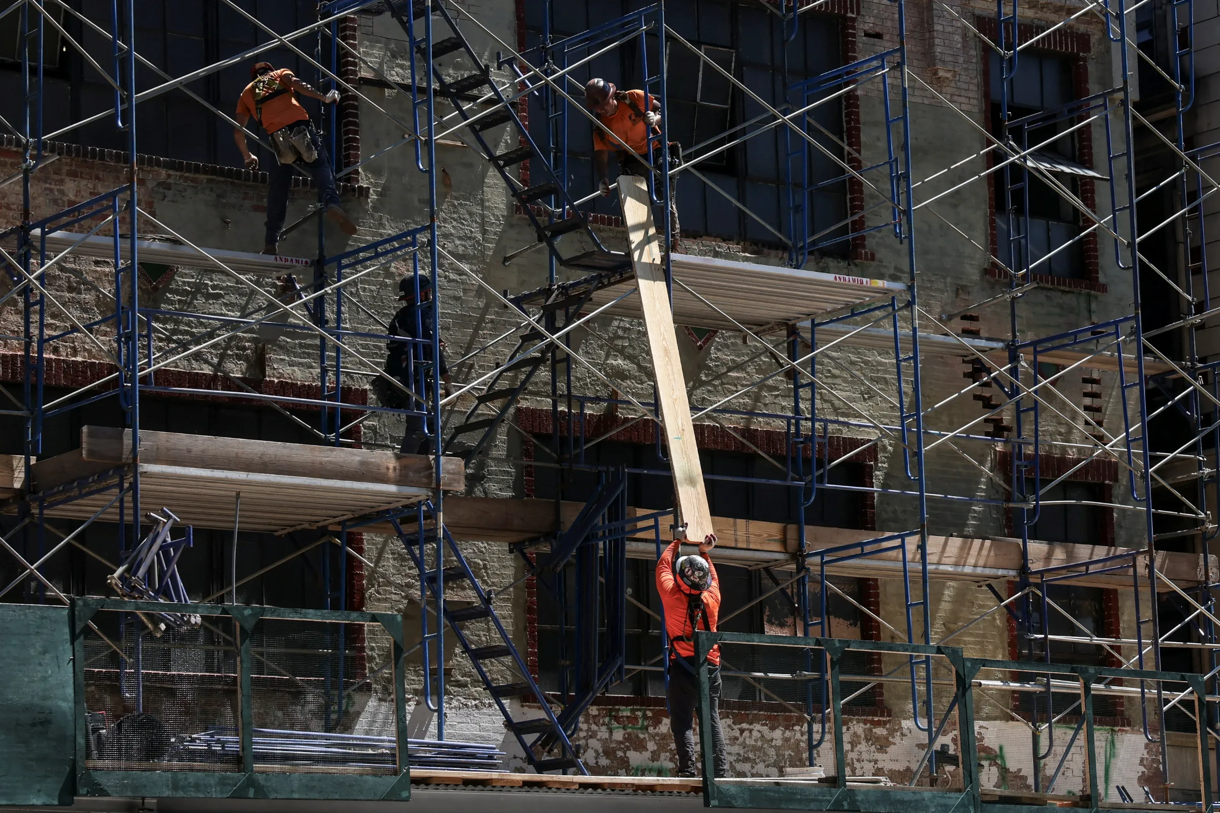 Construction laborers work during a summer heat wave in New York City, New York, U.S., July 11, 2024. REUTERS/Caitlin Ochs