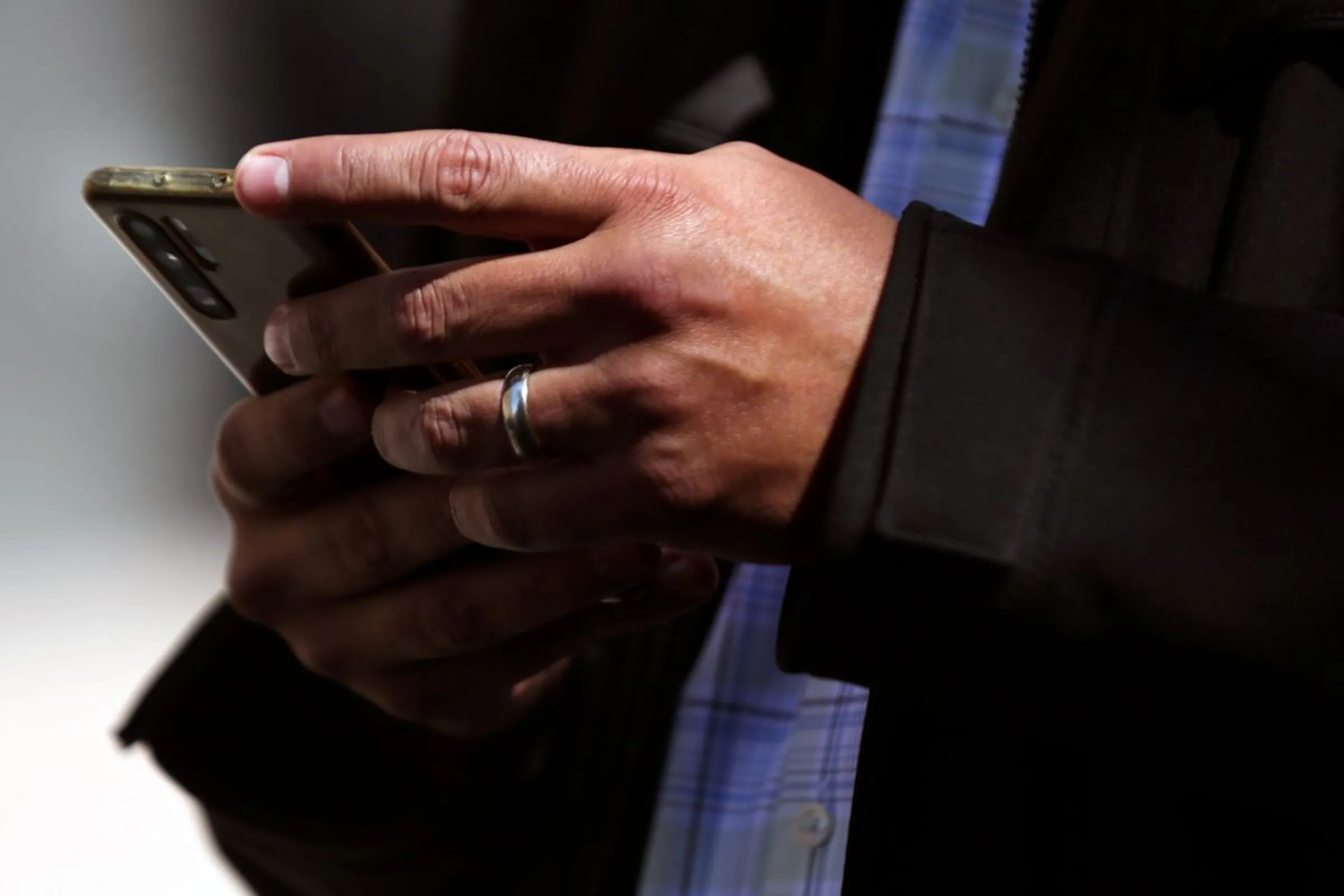 A man holds his mobile phone in downtown Mexico City, Mexico, February 3, 2021. Picture taken February 3, 2021. REUTERS/Edgard Garrido