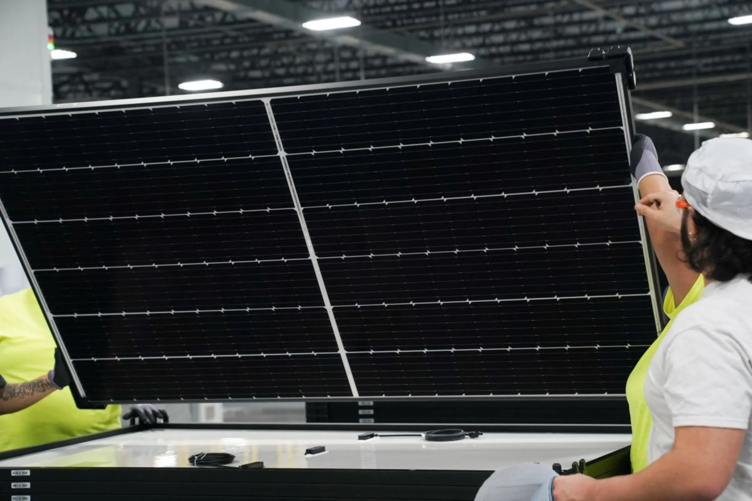An employee works on solar panels at the QCells solar energy manufacturing factory in Dalton, Georgia, U.S., March 2, 2023. REUTERS/Megan Varner