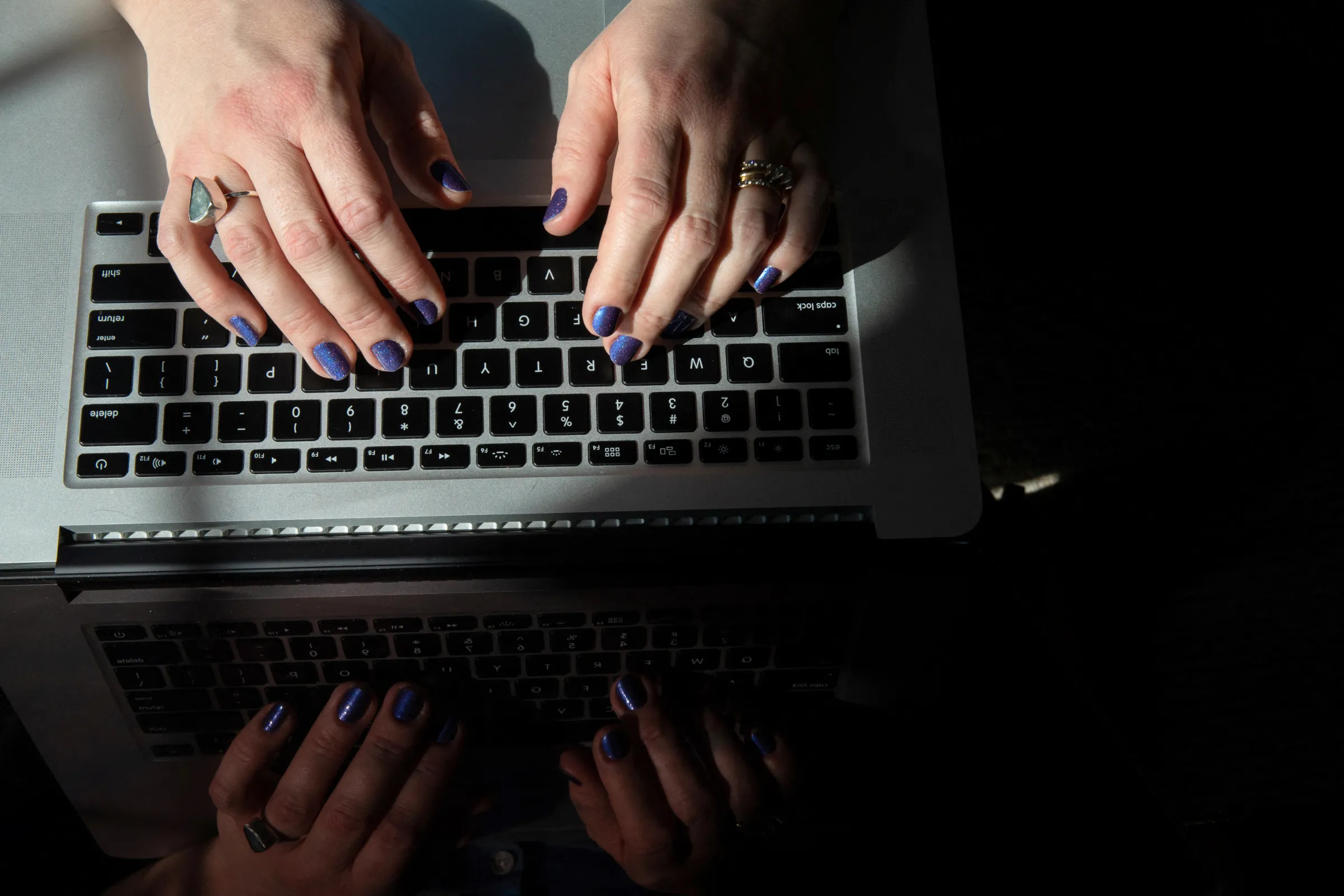 A woman works on her laptop in Grand Rapids, Michigan, U.S., March 2, 2021. REUTERS/Emily Elconin