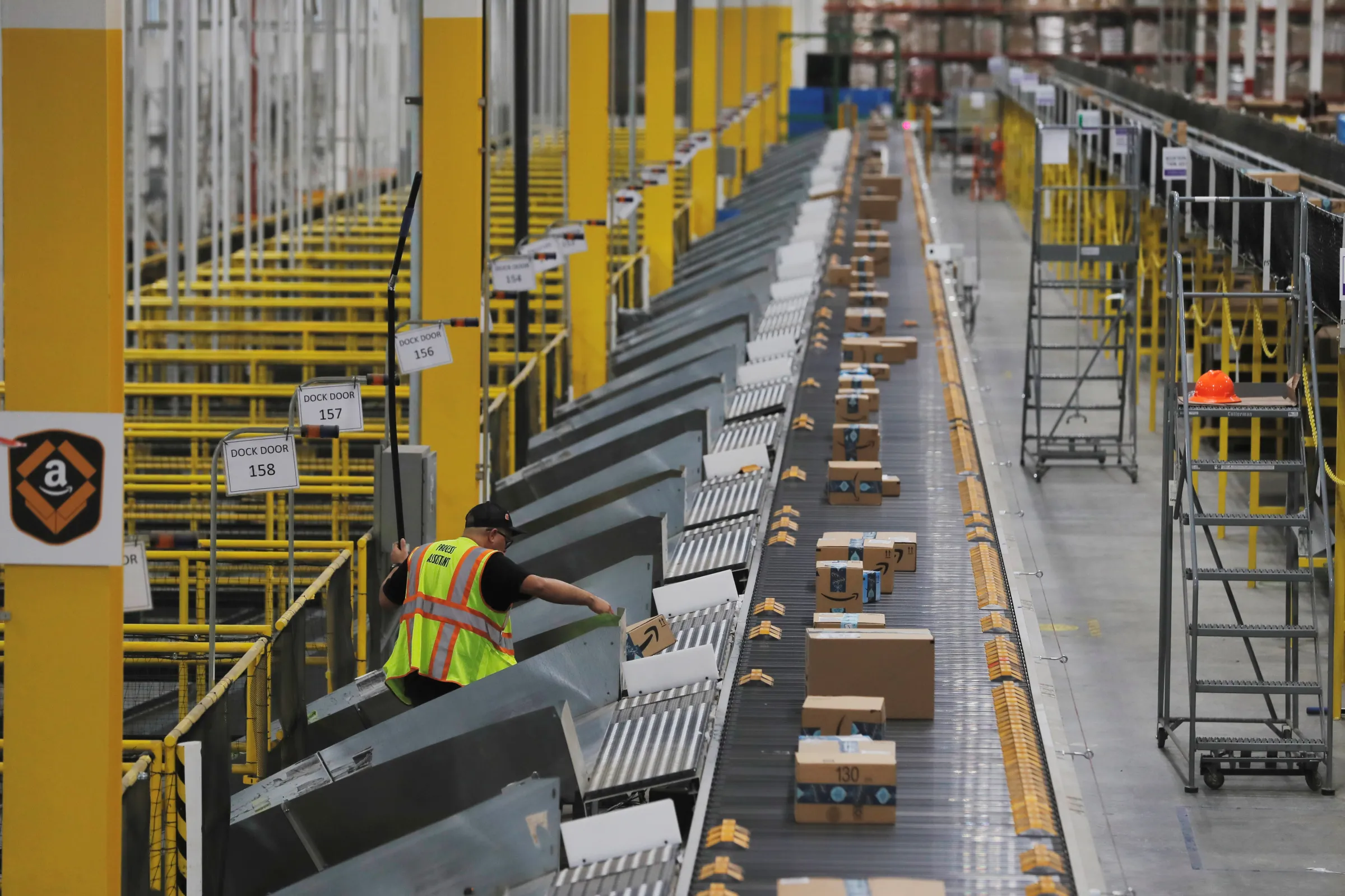 Amazon packages are pushed onto ramps leading to delivery trucks by a robotic system as they travel on conveyor belts inside of an Amazon fulfillment center on Cyber Monday in Robbinsville, New Jersey, U.S., December 2, 2019. REUTERS/Lucas Jackson