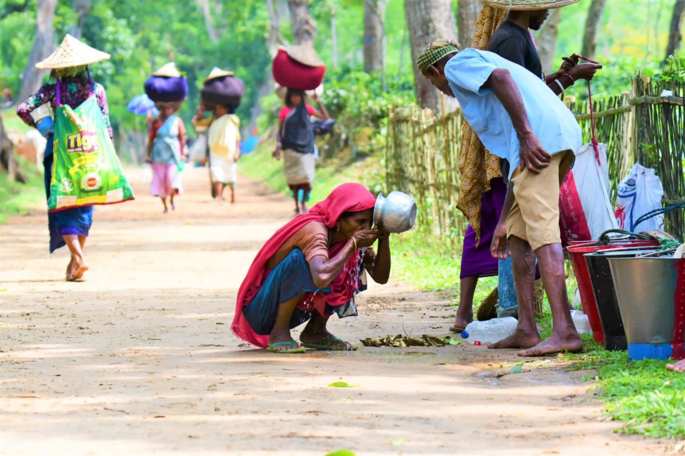 Jitni Hazra, a tea picker, drinks water during a rest period at Barawura, a tea estate in Sreemangal, in northeastern Bangladesh, May 27, 2023