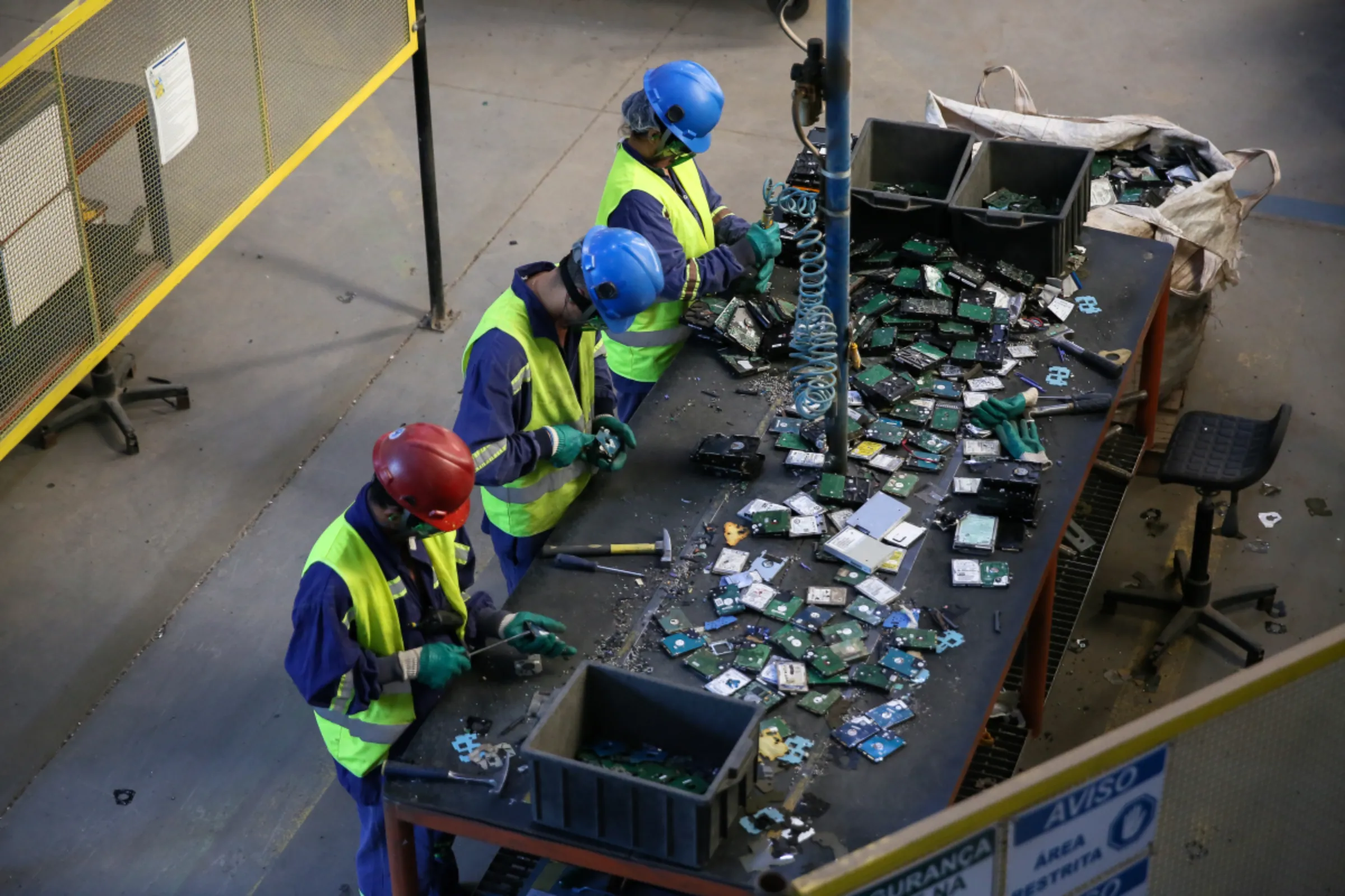 A group of workers at a landfill in Caieiras pick through tech garbage for precious minerals, in Caieiras, Brazil, July 22, 2022