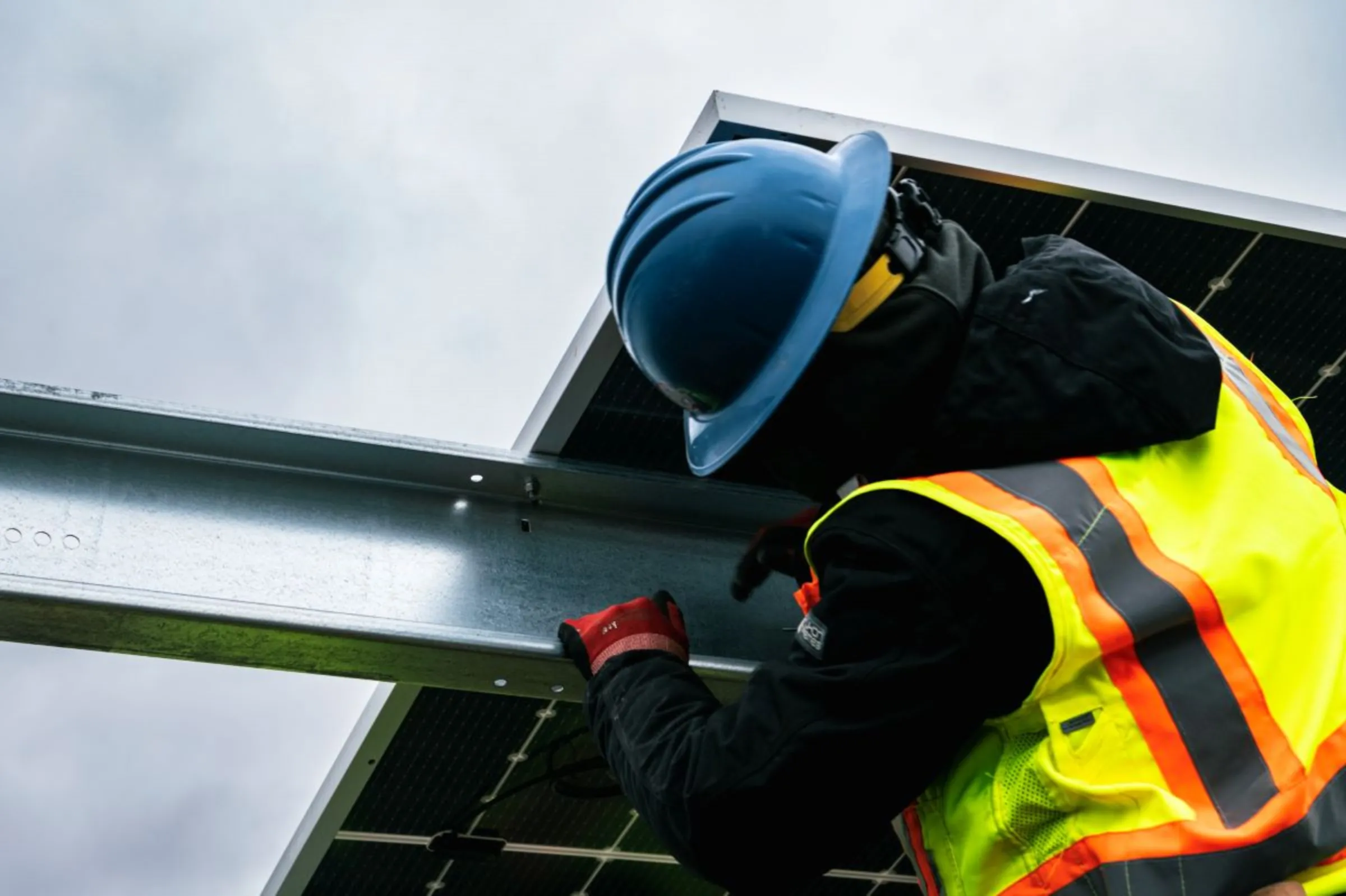 Union workers mount solar panels on a project in Rhode Island on March 23, 2023. Rafeed Hussain/Handout via Thomson Reuters Foundation