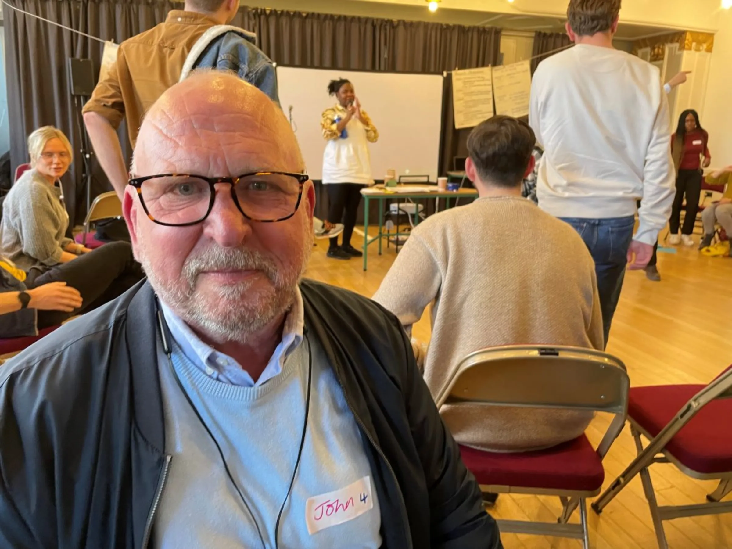 Retired engineer John Burnett of Tooting, in the London borough of Wandsworth, takes part in a citizen’s assembly on air quality in the borough, April 28, 2023. Thomson Reuters Foundation/Laurie Goering