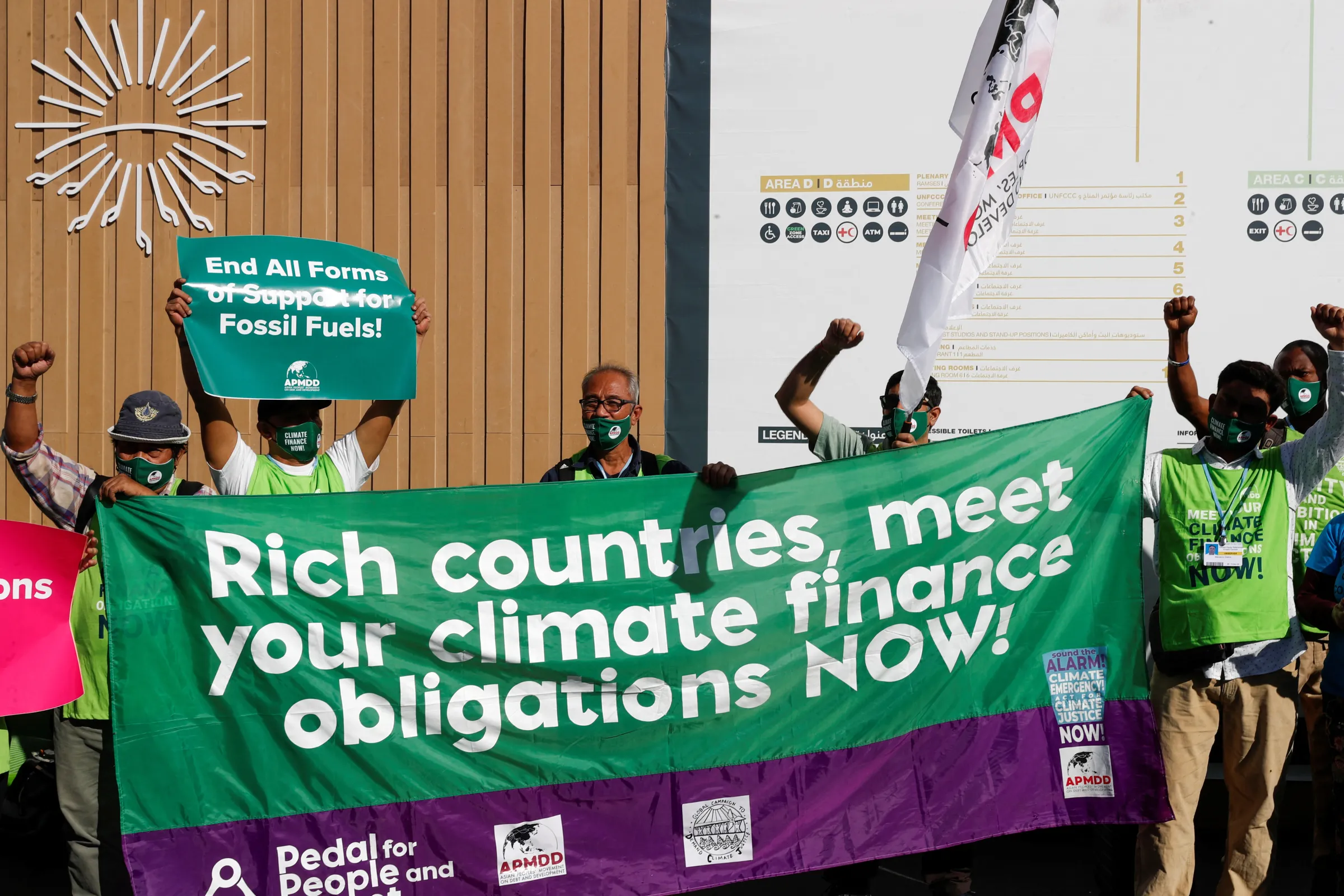 Activists hold banners as they demonstrate at the Sharm El Sheikh International Convention Centre, during the COP27 climate summit, in Sharm el-Sheikh, Egypt, November 9, 2022