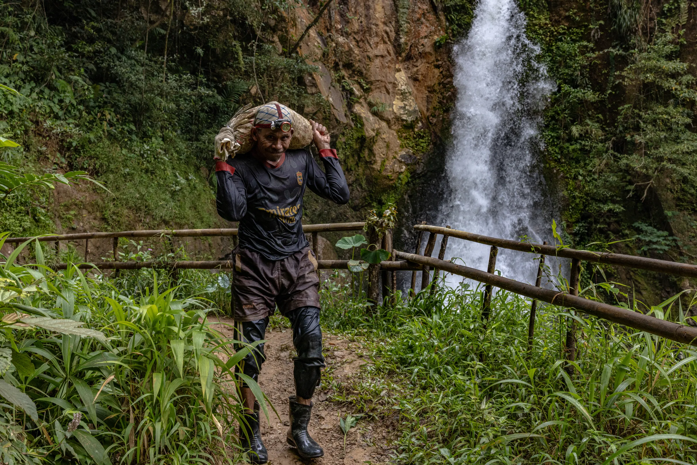 A mine worker carries a sack filled with rock chunks suspected to contain gold in Citorek Kidul, Banten, Indonesia, July 14, 2025. Thomson Reuters Foundation/Yudha Baskoro
