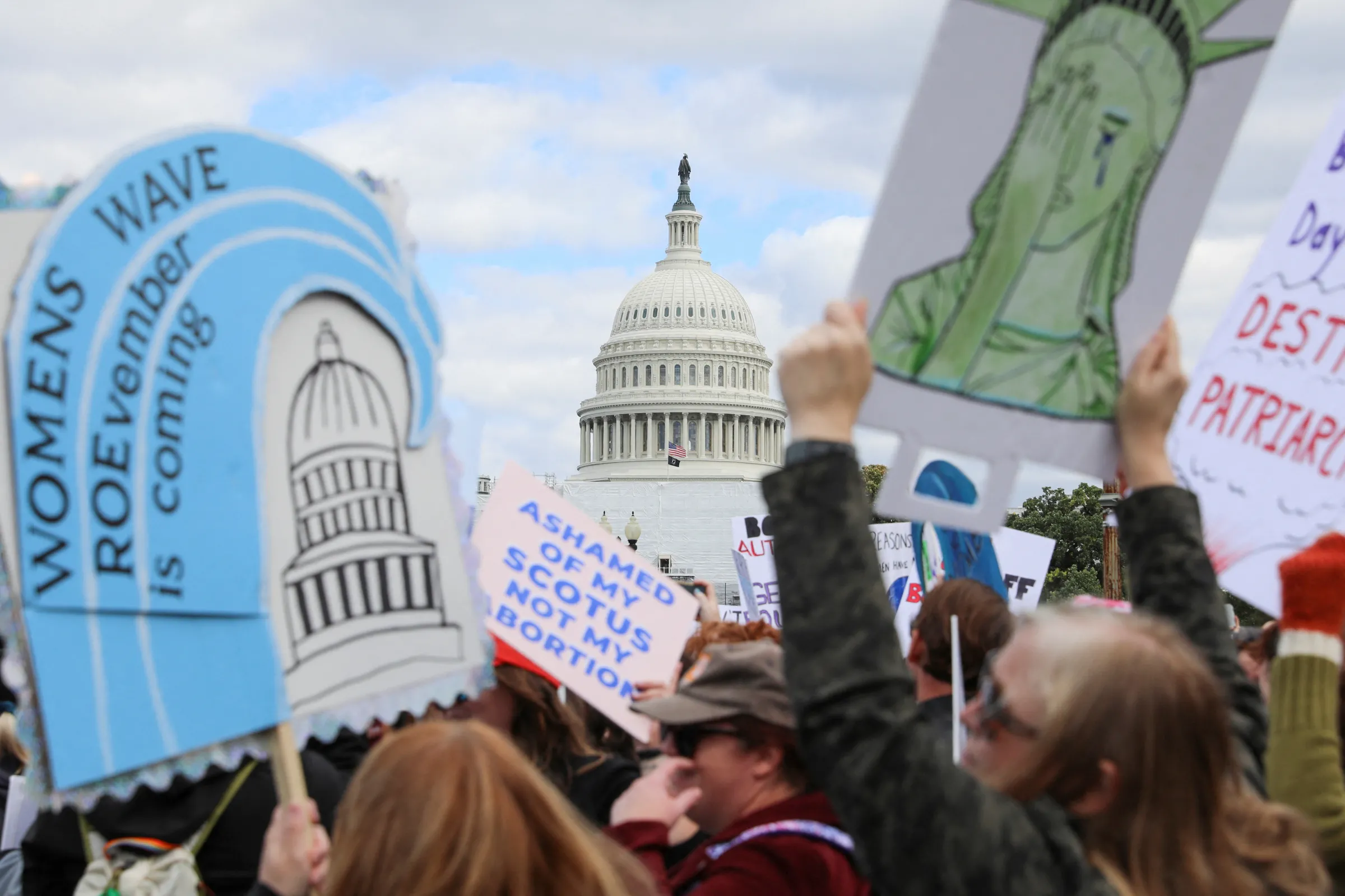 Abortion rights activists carry signs during a 2022 Women's March with the theme “We Demand Our Rights” in anticipation of the upcoming U.S. midterm elections on Capitol Hill in Washington, U.S. October 8, 2022