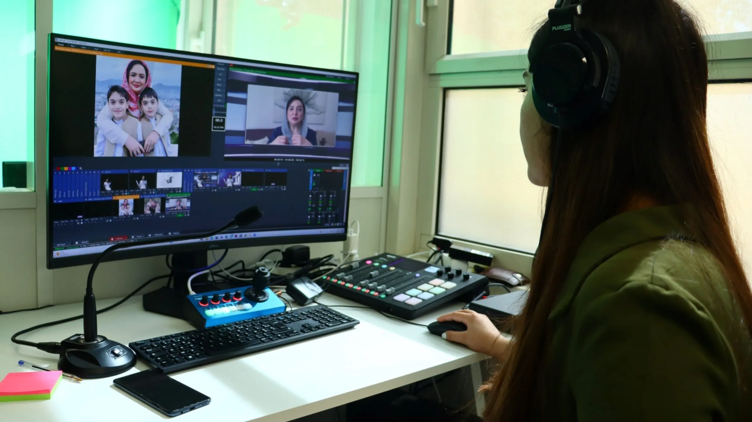 Begum TV's Getee Azami records presenter Diba Akbari's show in Paris. Begum Organization for Women/Handout via Thomson Reuters Foundation