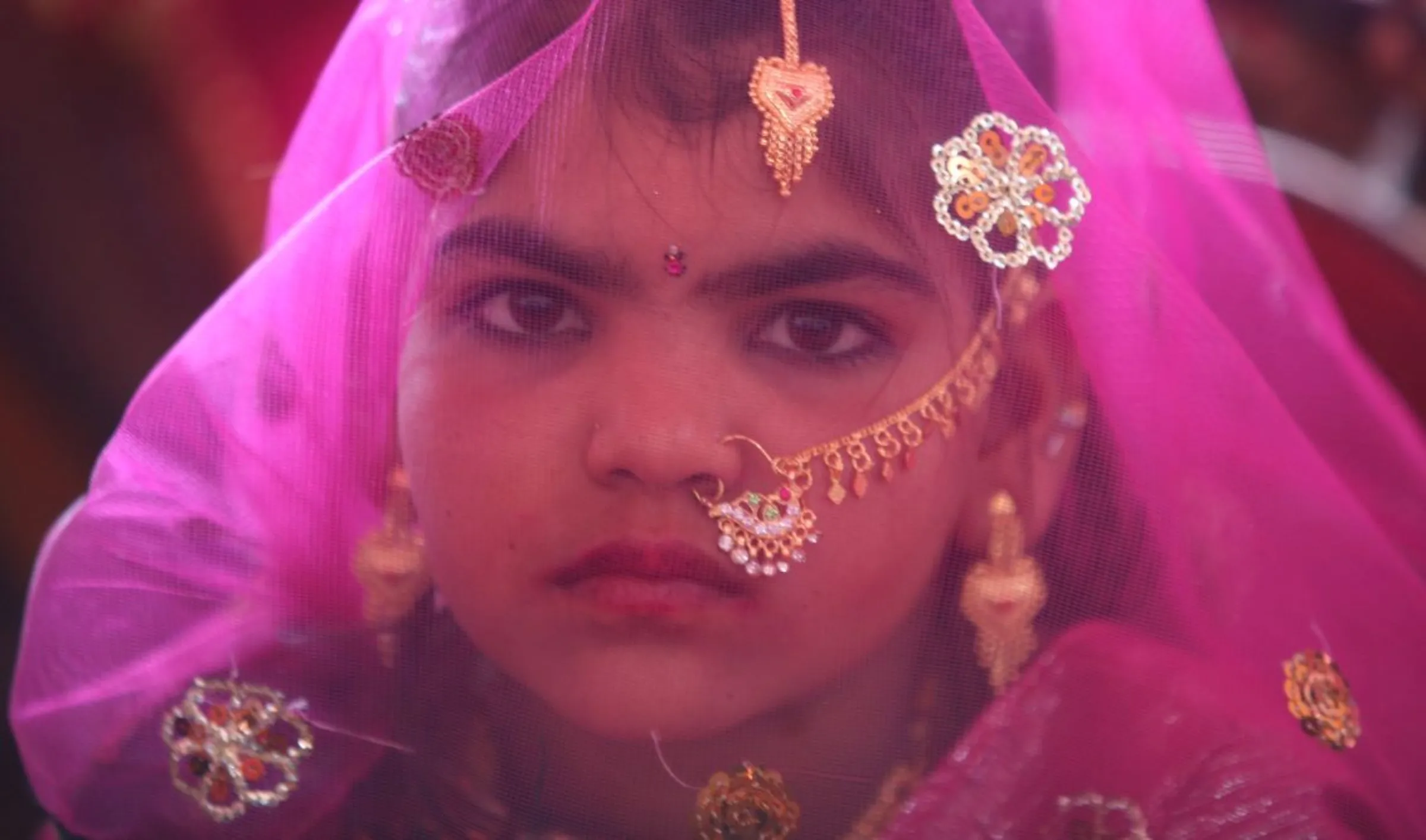 A veiled girl from the Saraniya community waits for her engagement ceremony to start at Vadia village in the western Indian state of Gujarat March 11, 2012
