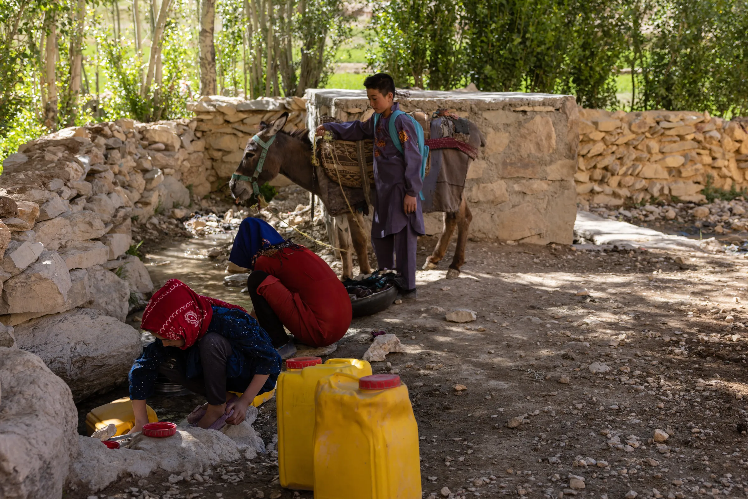 Children fetch water ten minutes from their village as all other water sources have dried up