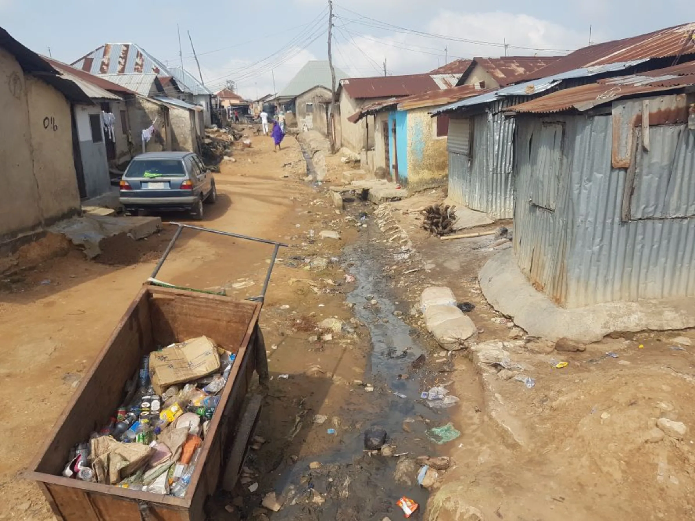 Houses on a street in Abuja's Big Bola slum, built with corrugated iron sheets beside dirty water channels in Abuja, Nigeria. October 26, 2022