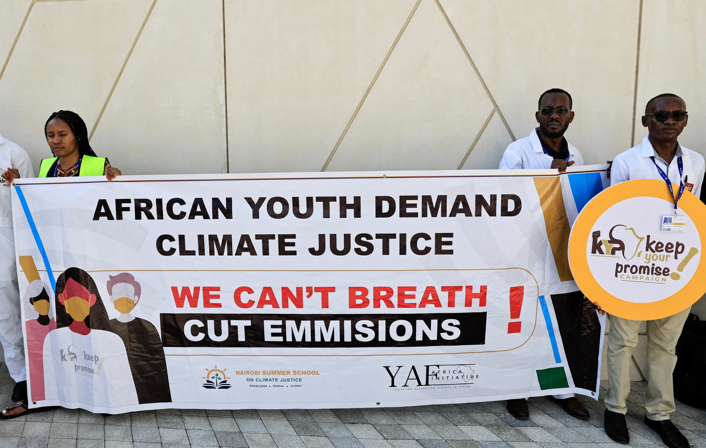 Activists hold a sign that reads 'African youth demand climate justice' during a protest, at the United Nations Climate Change Conference COP28 in Dubai, United Arab Emirates, December 5, 2023. REUTERS/Thaier Al-Sudani