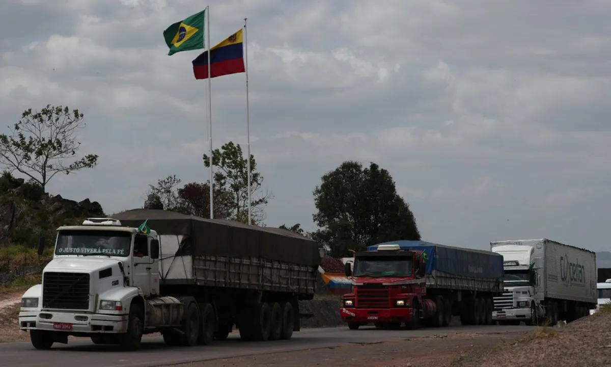Brazilian trucks drive back to Brazil after they were authorised to cross from Venezuela at the border in Pacaraima, Brazil February 27, 2019