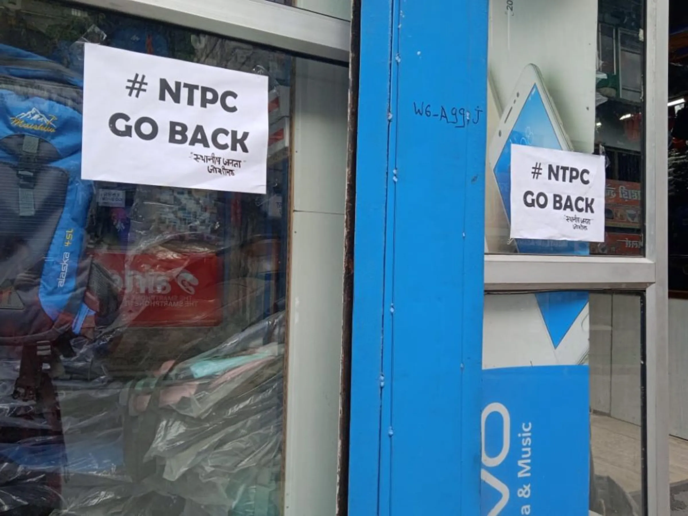 A poster with the slogan 'NTPC Go Back' signed by local residents is stuck on a shop in the sinking Himalayan town of Joshimath, India, Jan 18, 2023