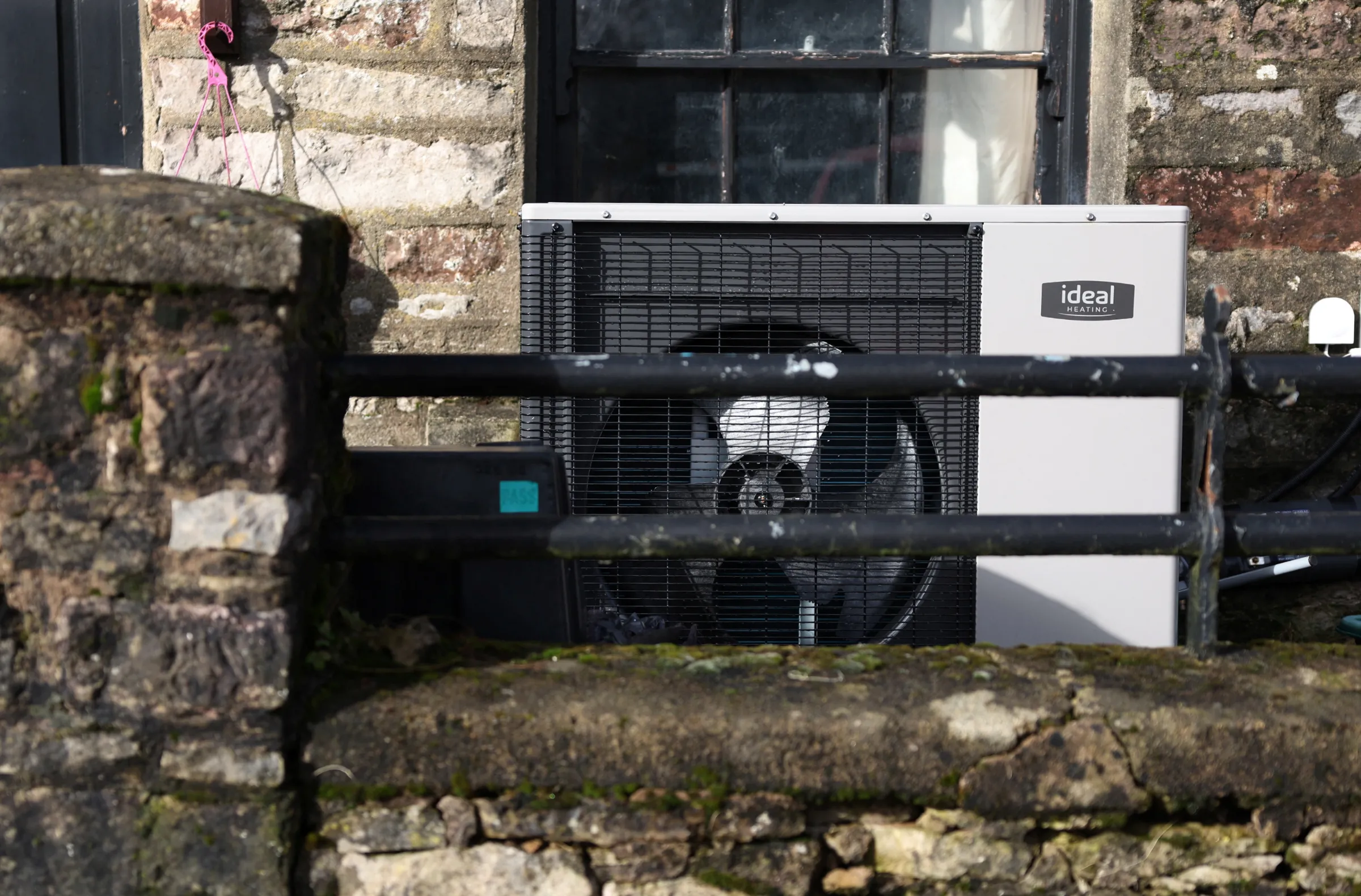 An Ideal Heating heat pump is seen in front of a cottage in Newbiggin-on-Lune, Britain, February 18, 2024. REUTERS/Suzanne Plunkett