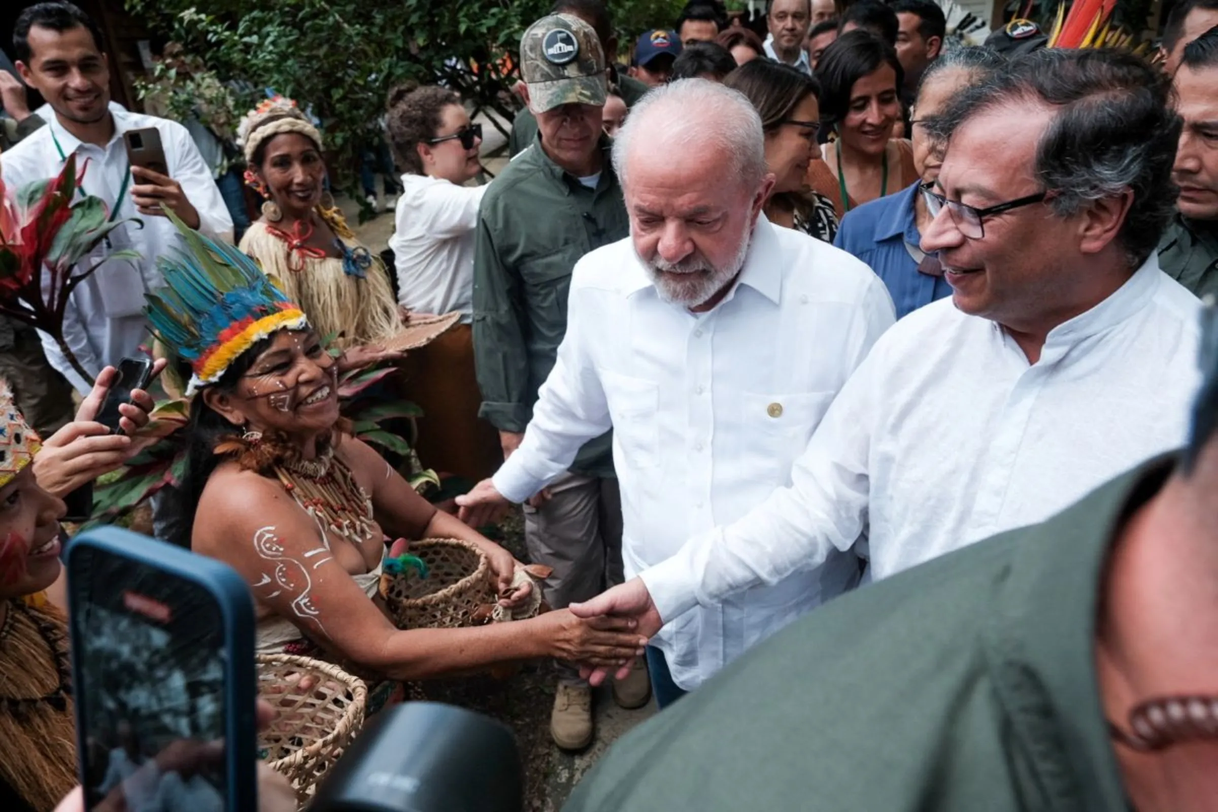 Colombian President Gustavo Petro and Brazilian President Luiz Inacio Lula da Silva greet indigenous people upon their arrival at the event 'Road to the Amazon Summit' in Leticia, Colombia July 8, 2023. Colombian Presidency/Handout via REUTERS