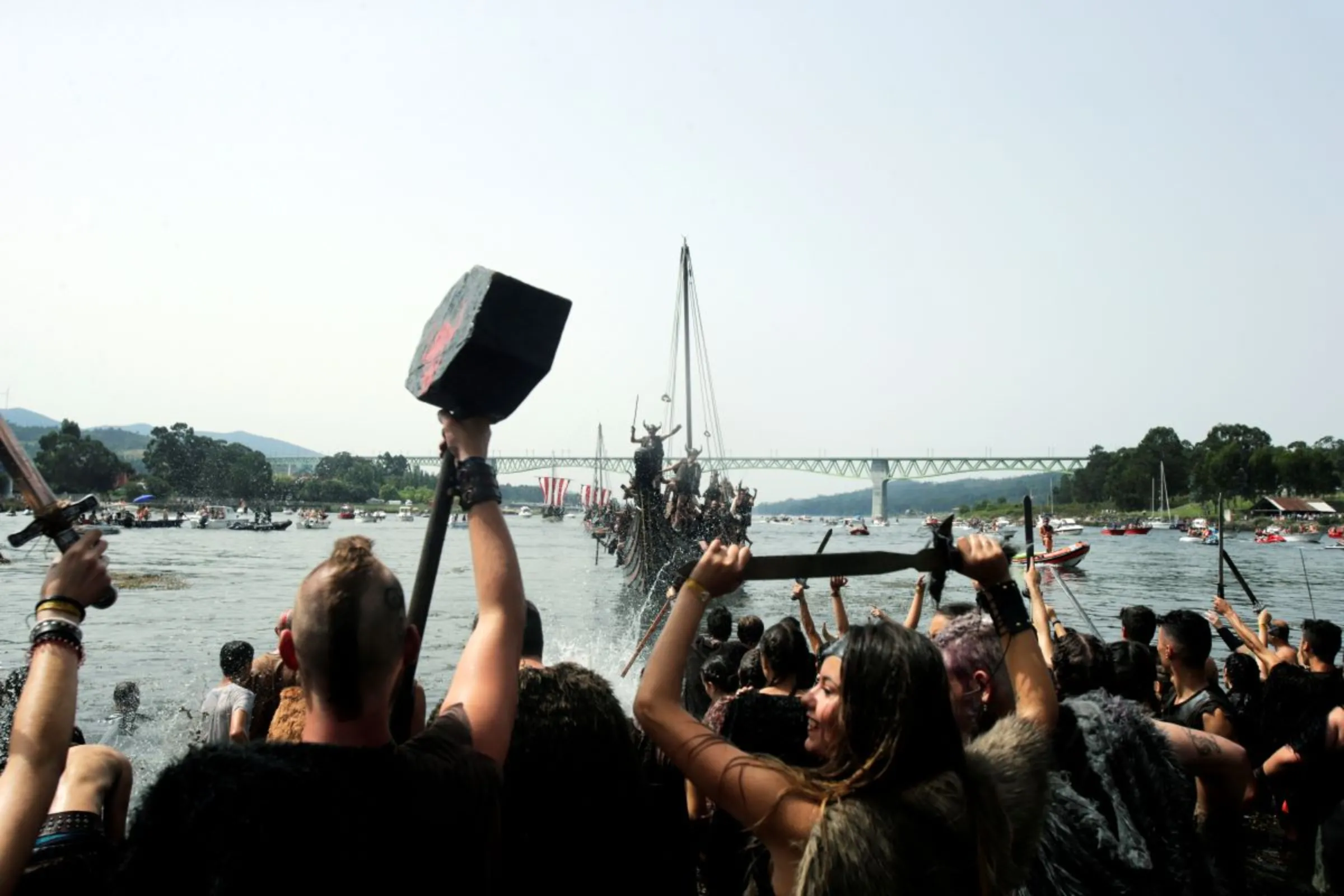 People dressed as Vikings sail on a boat during the annual Viking festival of Catoira in north-western Spain August 5, 2018. The festival re-enacts past Viking raids in the area and is celebrated annually. REUTERS/Miguel Vidal