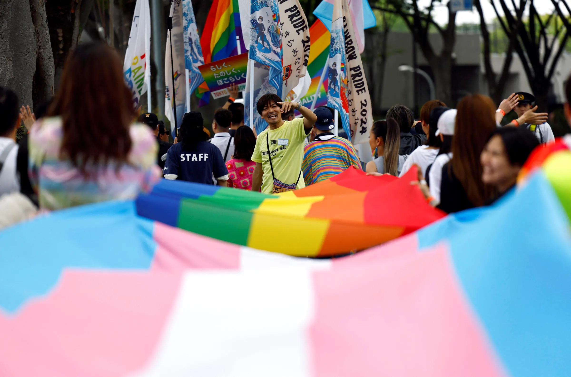 Participants hold flags, as they march during the Tokyo Rainbow Pride parade, celebrating advances in LGBTQ+ rights and calling for marriage equality, in Tokyo, Japan April 21, 2024. REUTERS/Issei Kato