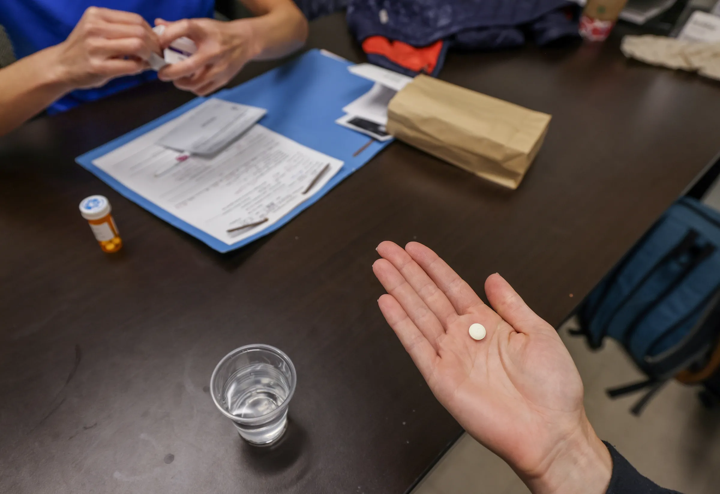 A doctor hands a patient the initial abortion inducing medication at Trust Women clinic in Oklahoma City, U.S., December 6, 2021. REUTERS/Evelyn Hockstein