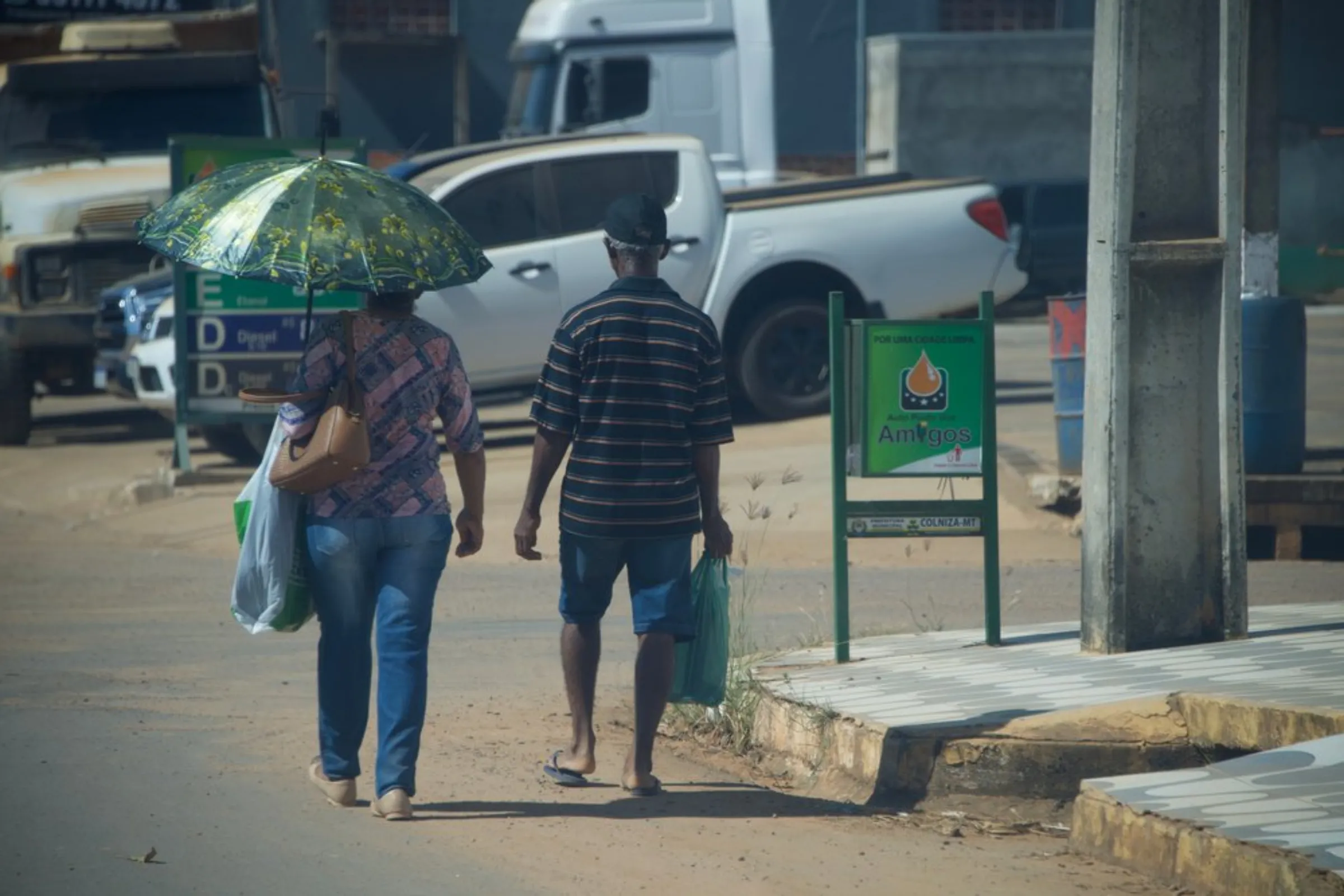 A couple walks down a street in Colniza, in the state of Mato Grosso, Brazil, May 31, 2022