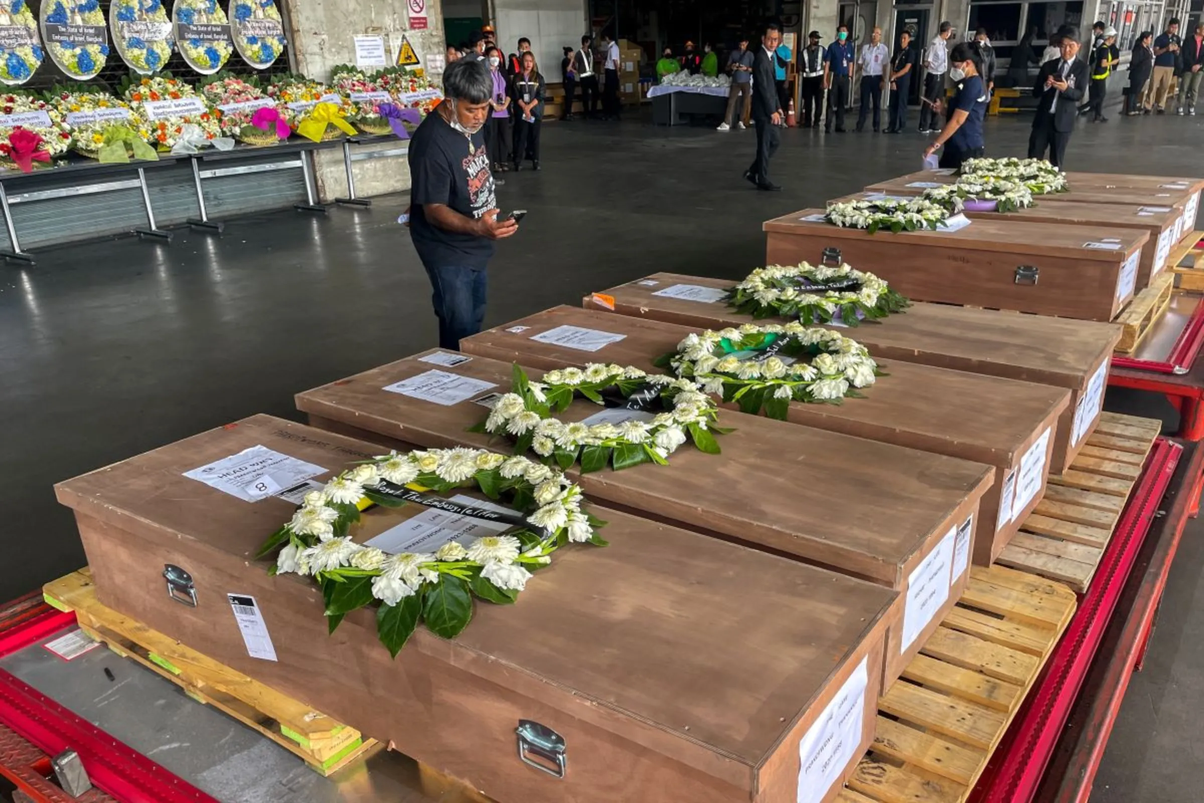 Coffins carrying bodies of Thai migrant agricultural workers who were killed in an attack by the Palestinian militant group Hamas on Israel, arrive at Bangkok's Suvarnabhumi Airport, Thailand, October 20, 2023. REUTERS/Artorn Pookasook