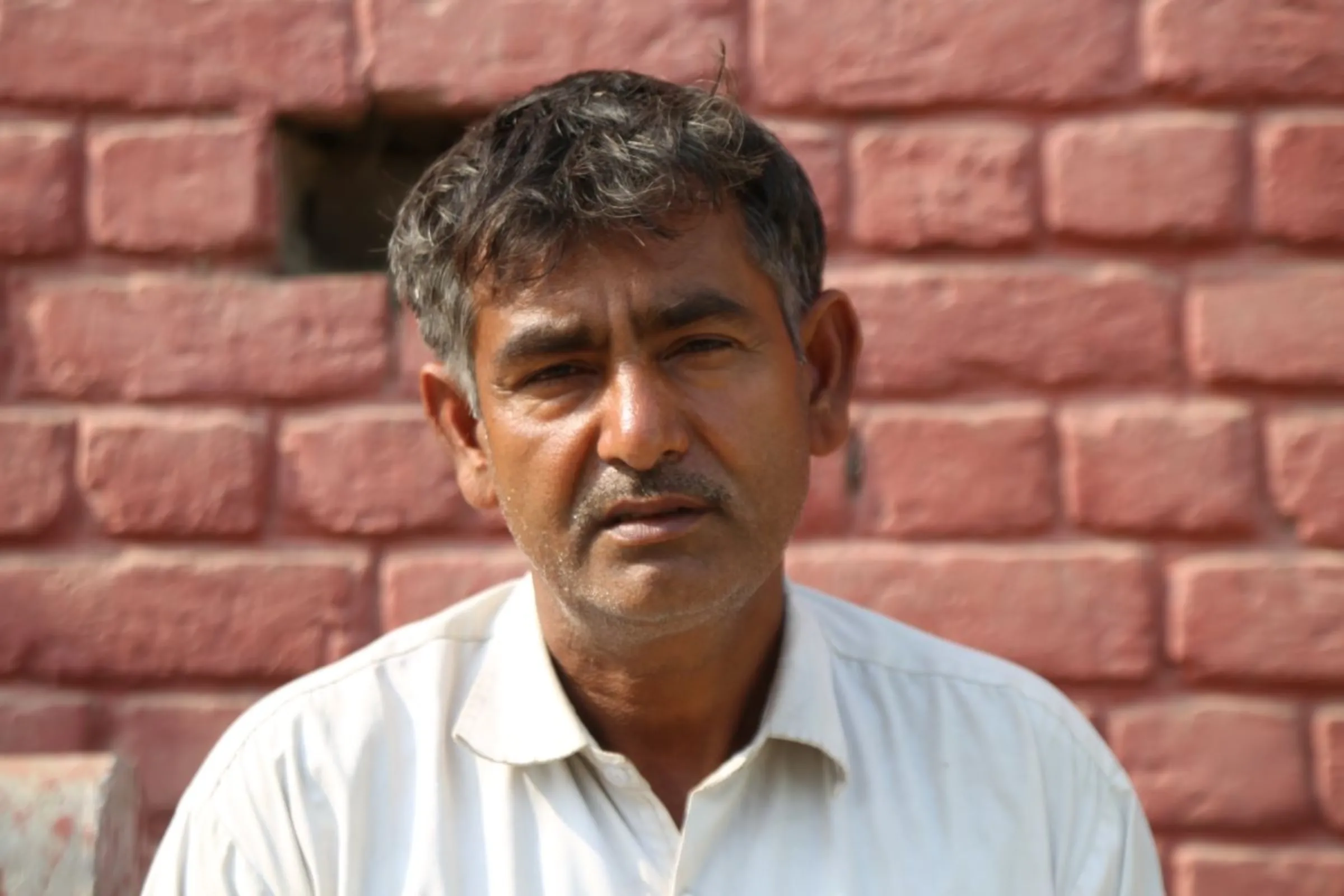 Suresh Kumar, whose nephew found work at a dairy farm in California after his illegal 'donkey' journey to the United States, poses for a photo in Dhatrath, India, December 4, 2023. Thomson Reuters Foundation/Annie Banerji