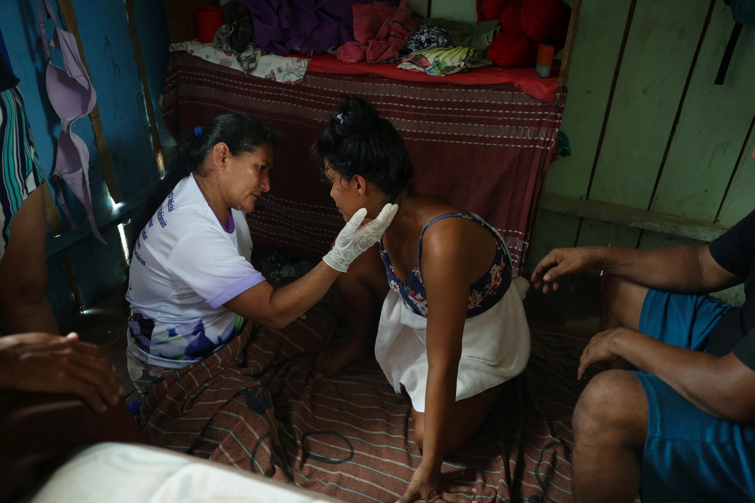 A community midwife calms a woman during the birth of her baby at the Deus e Pai community in Tefe, Amazonas state, Brazil, October 26, 2024. REUTERS/Pilar Olivares