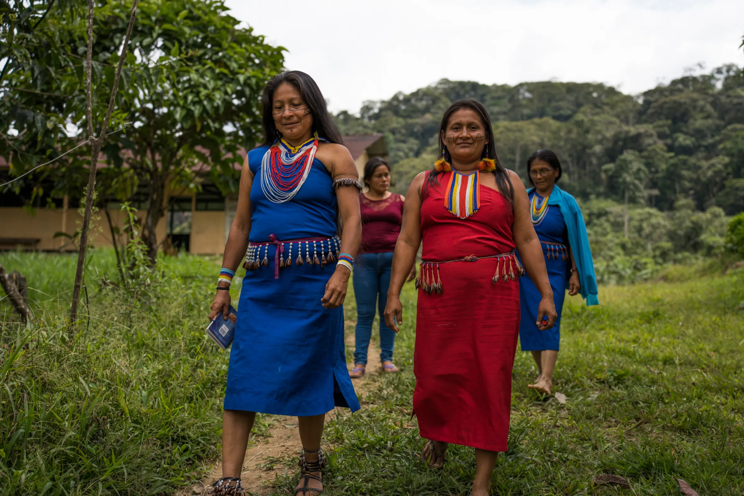Dressed in traditional Shuar outfits, indigenous leaders Teresa Tupikia (left) and Margarita Jempekat (right), attend a special workshop about the mining threats in their communities
