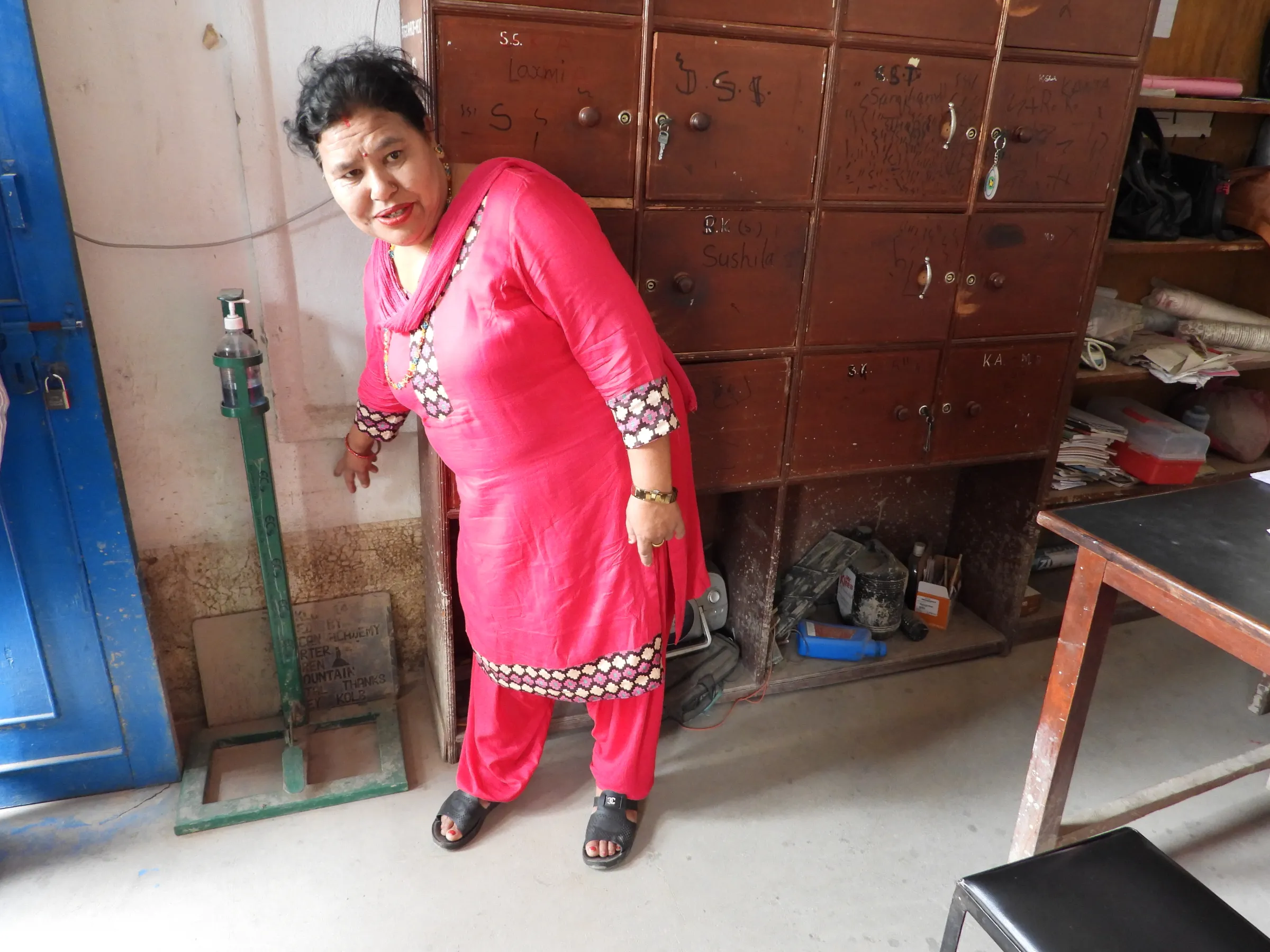 School principal Indira Mahat shows the traces of flood inundation level from August in a slum on the outskirts of Kathmandu, Nepal, September 8, 2022