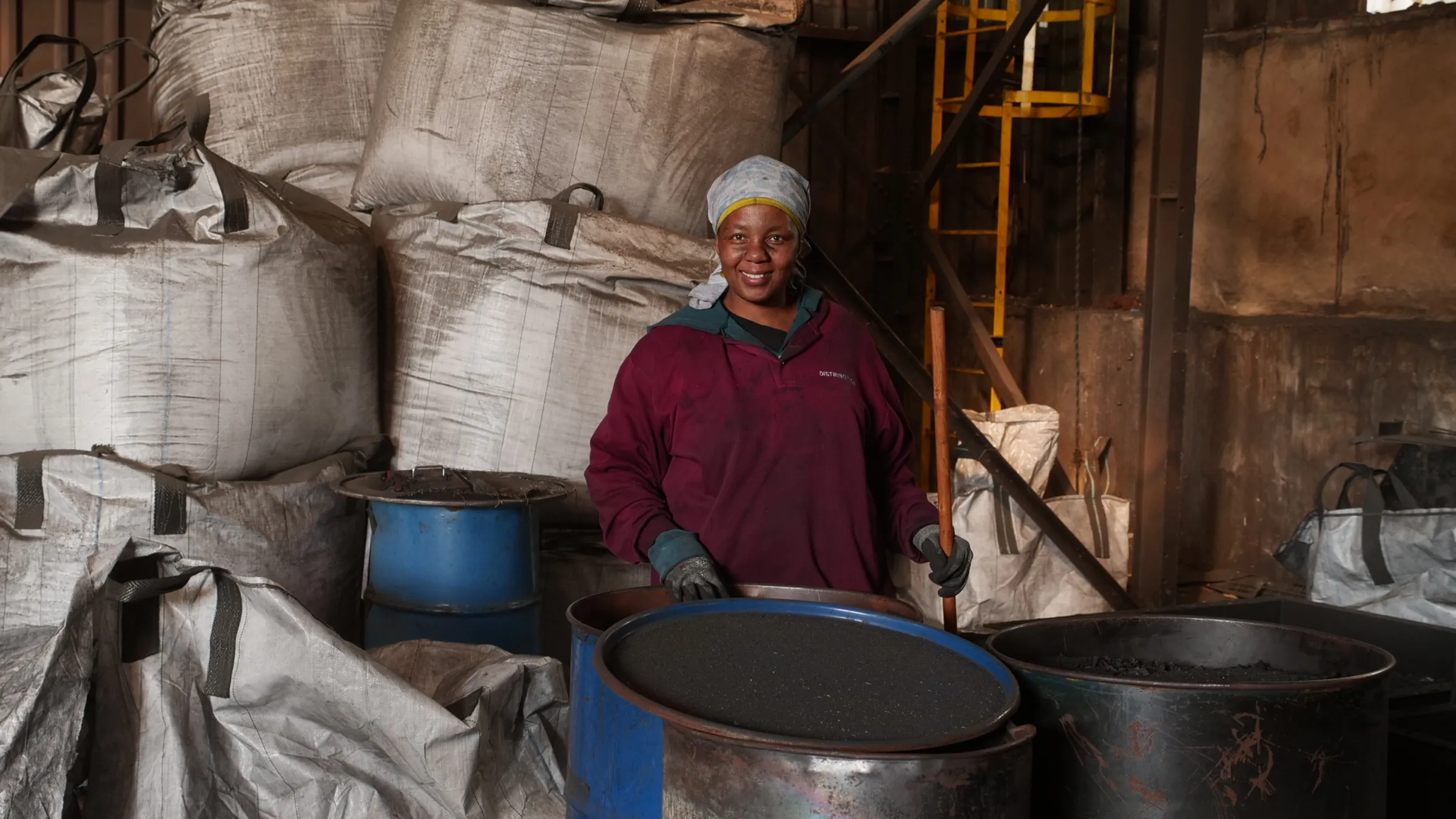 Sithandekile Nyathi, a controller at the charcoal plant, smiles for a photo as she works in Brakpan, Johannesburg, South Africa, June 8, 2025. Thomson Reuters Foundation/Kim Harrisberg