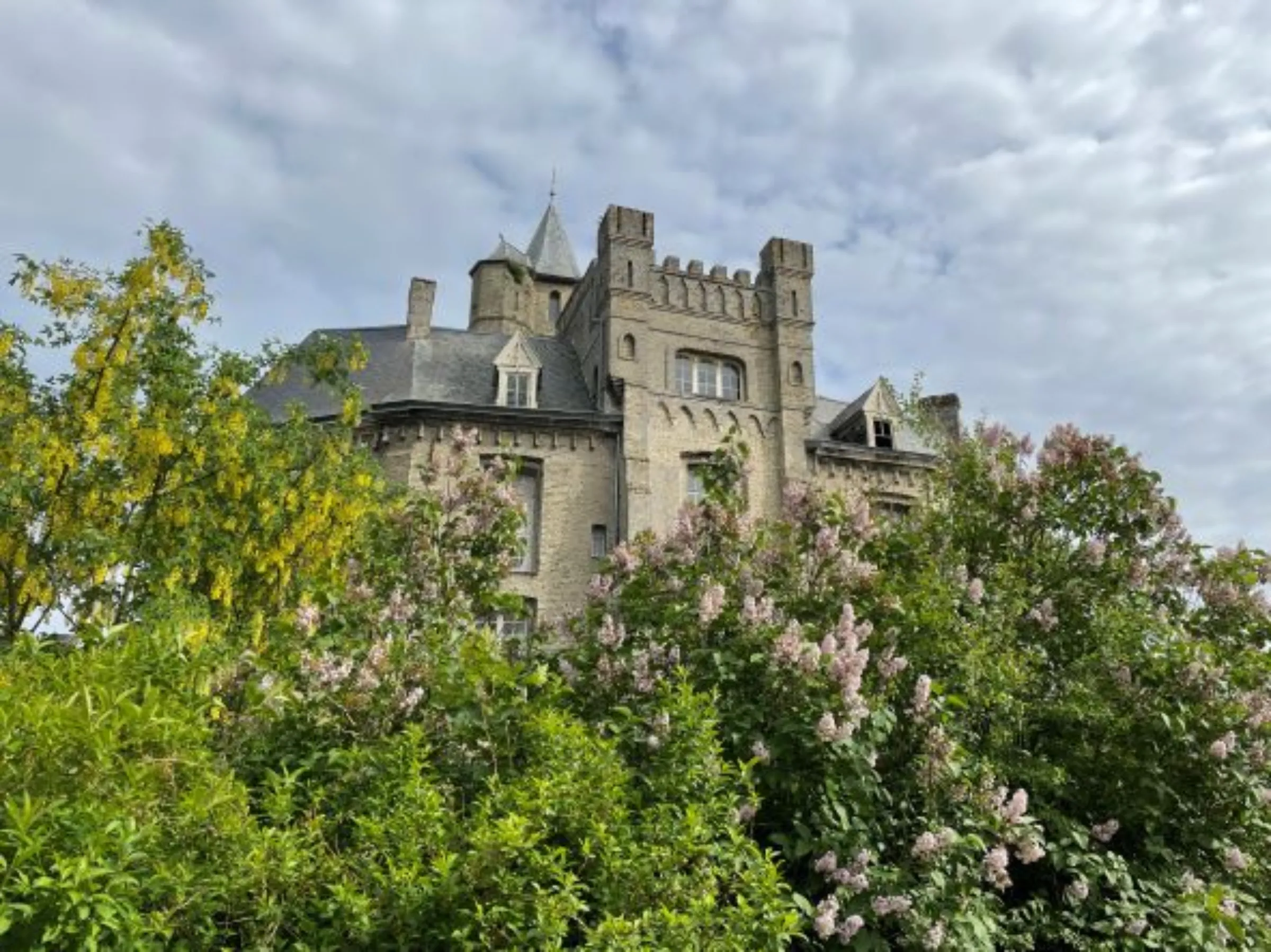 The castle in Tilques is seen through the treetops, May 10, 2022.Thomson Reuters Foundation/Emma Batha