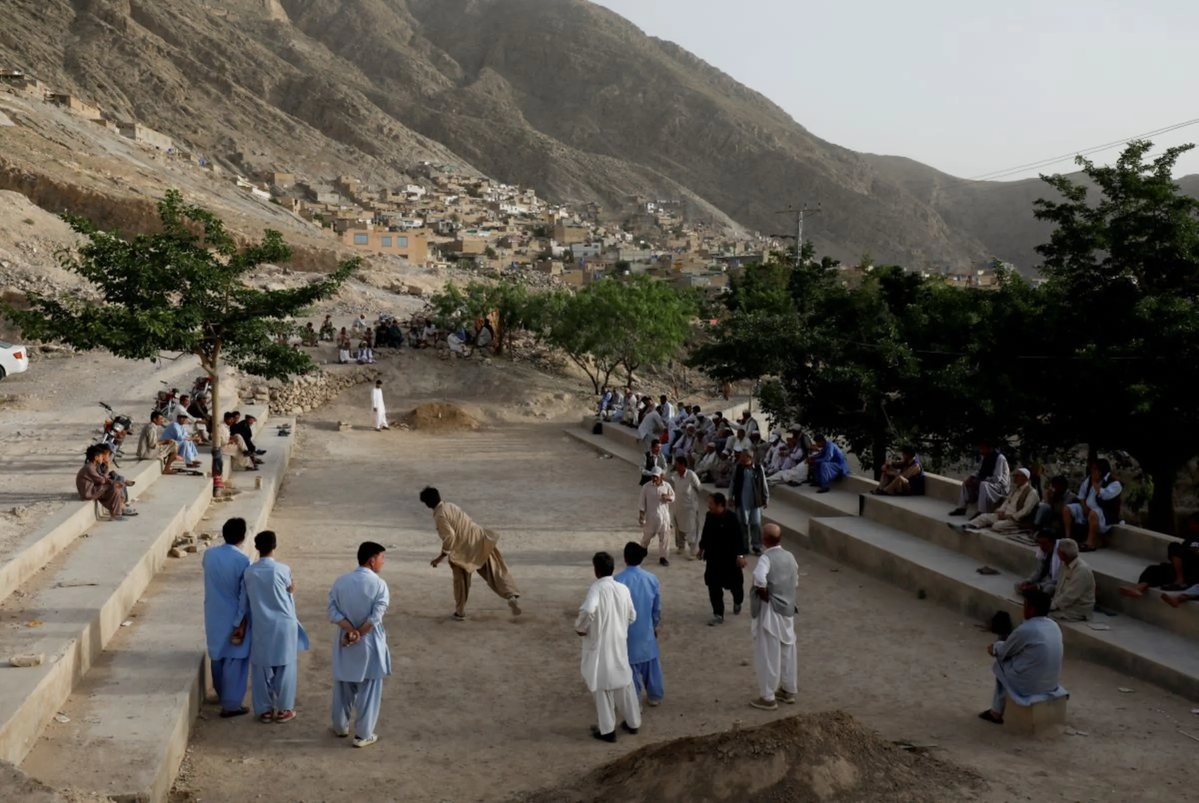 People from ethnic Hazara community play a game Sang Girag (stone throwing) near a graveyard in Mariabad, Quetta, Pakistan, June 15, 2019. REUTERS/Akhtar Soomro