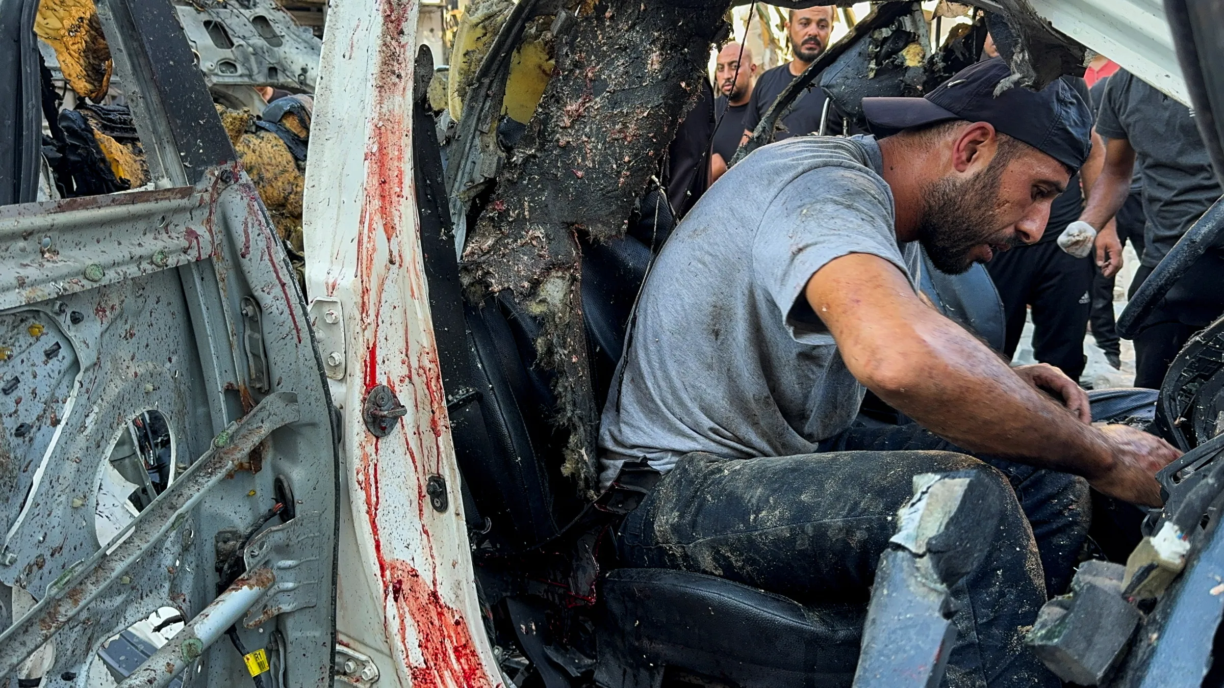 Palestinians inspect a vehicle where Al Jazeera TV said its reporter Ismail al-Ghoul and cameraman Ramy El Rify were killed in an Israeli strike, in Gaza City July 31, 2024. REUTERS/Ayman Al Hassi