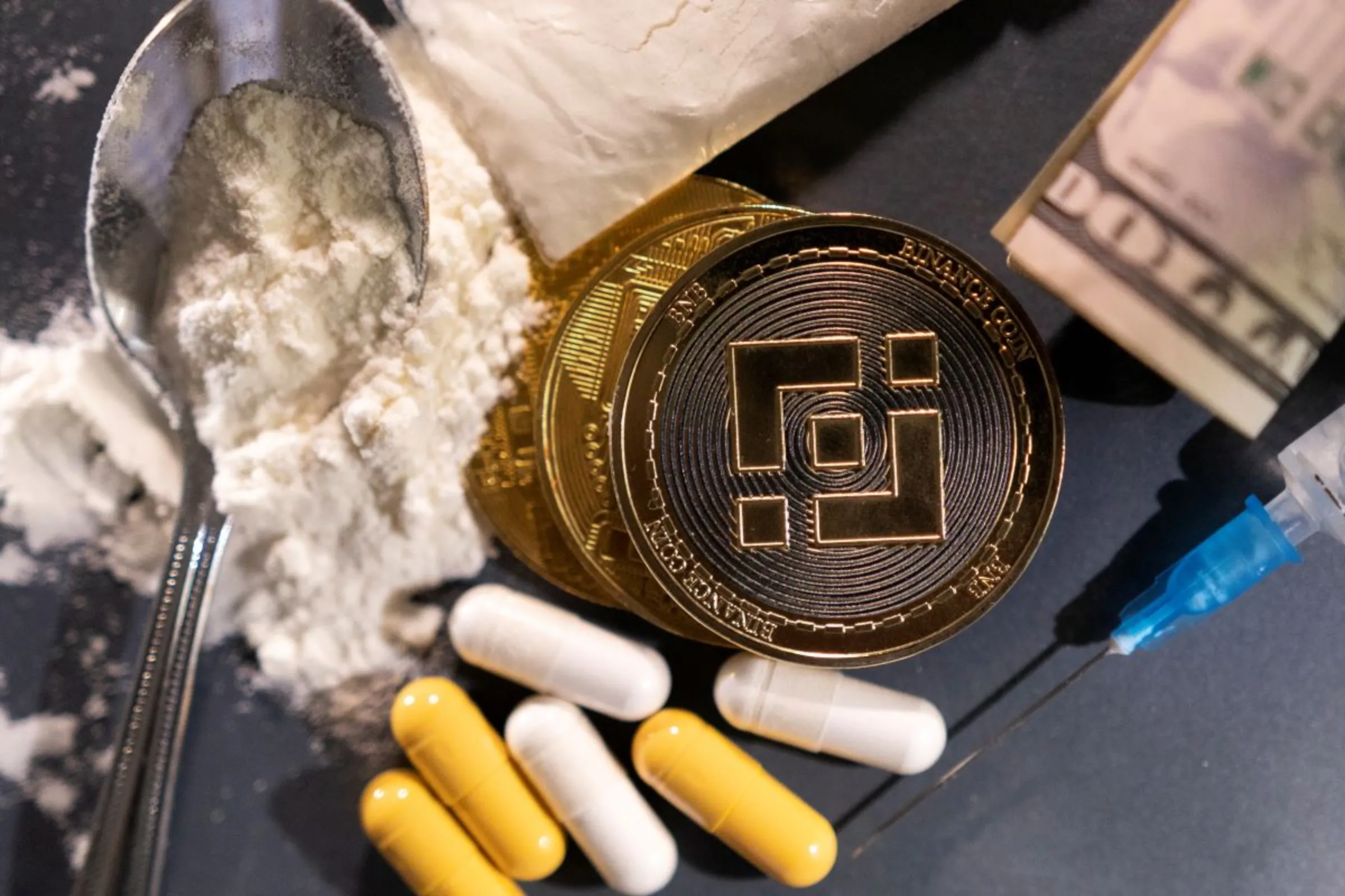 Representations of cryptocurrency exchange Binance and hard drugs are seen in this illustration taken, May 23, 2022. REUTERS/Dado Ruvic/Illustration