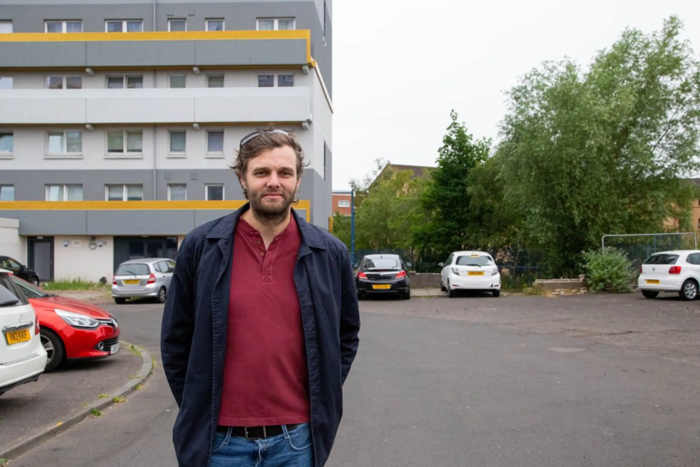 Architect Rupert Daly stands outside renovated Queens Cross Housing Association homes in Glasgow, United Kingdom, July 23, 2021. Daly said investing in high-quality green building improvements can work out cheaper in the long run as regulations on energy efficiency step up