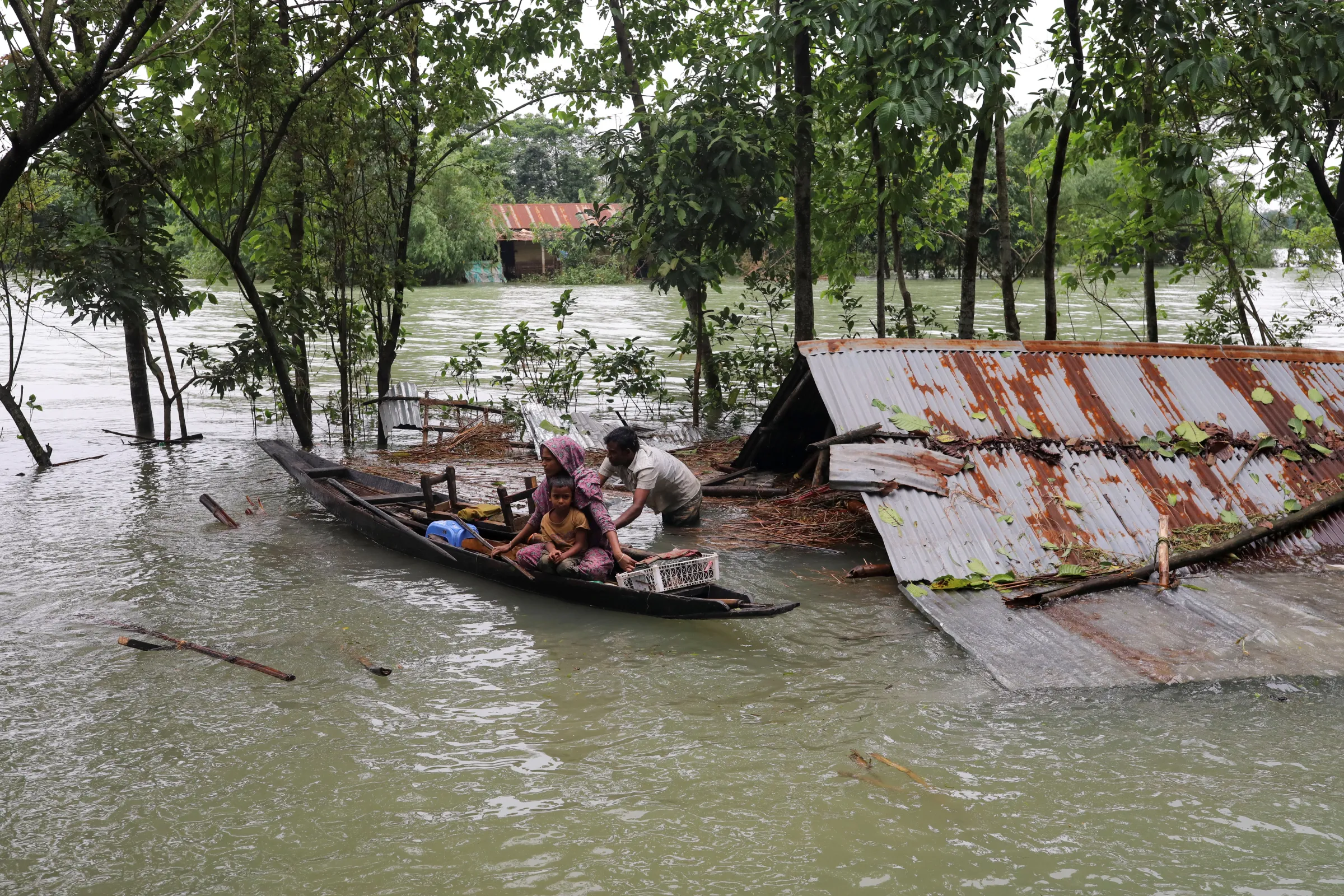 People get on a boat as they look for shelter during a widespread flood in the northeastern part of the country, in Sylhet, Bangladesh, June 19, 2022