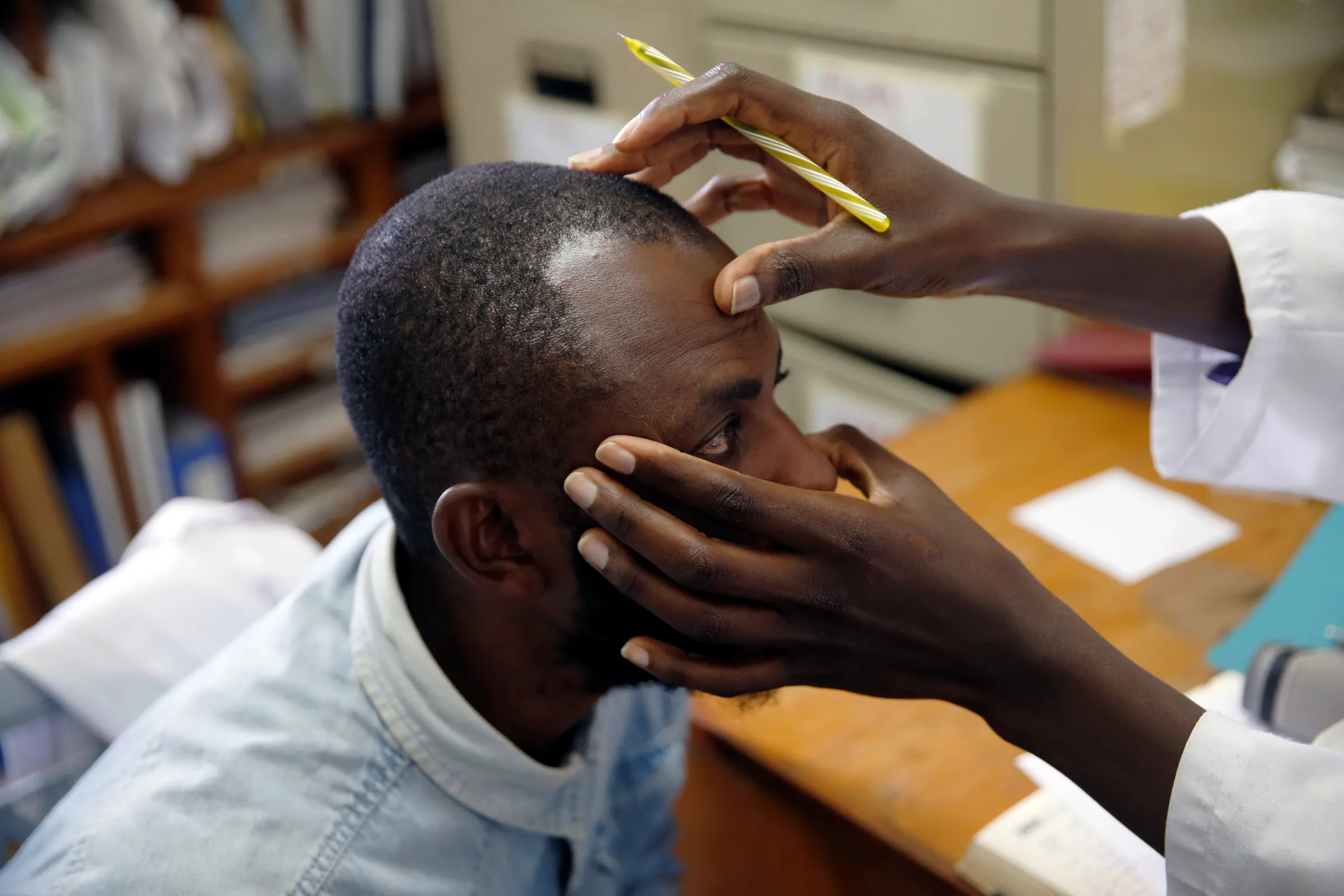 An HIV adherence counsellor examines an HIV positive patient at the IOM treatment centre in Eastleigh, Nairobi, Kenya, November 29, 2018. Picture taken November 29, 2018 REUTERS/Baz Ratne