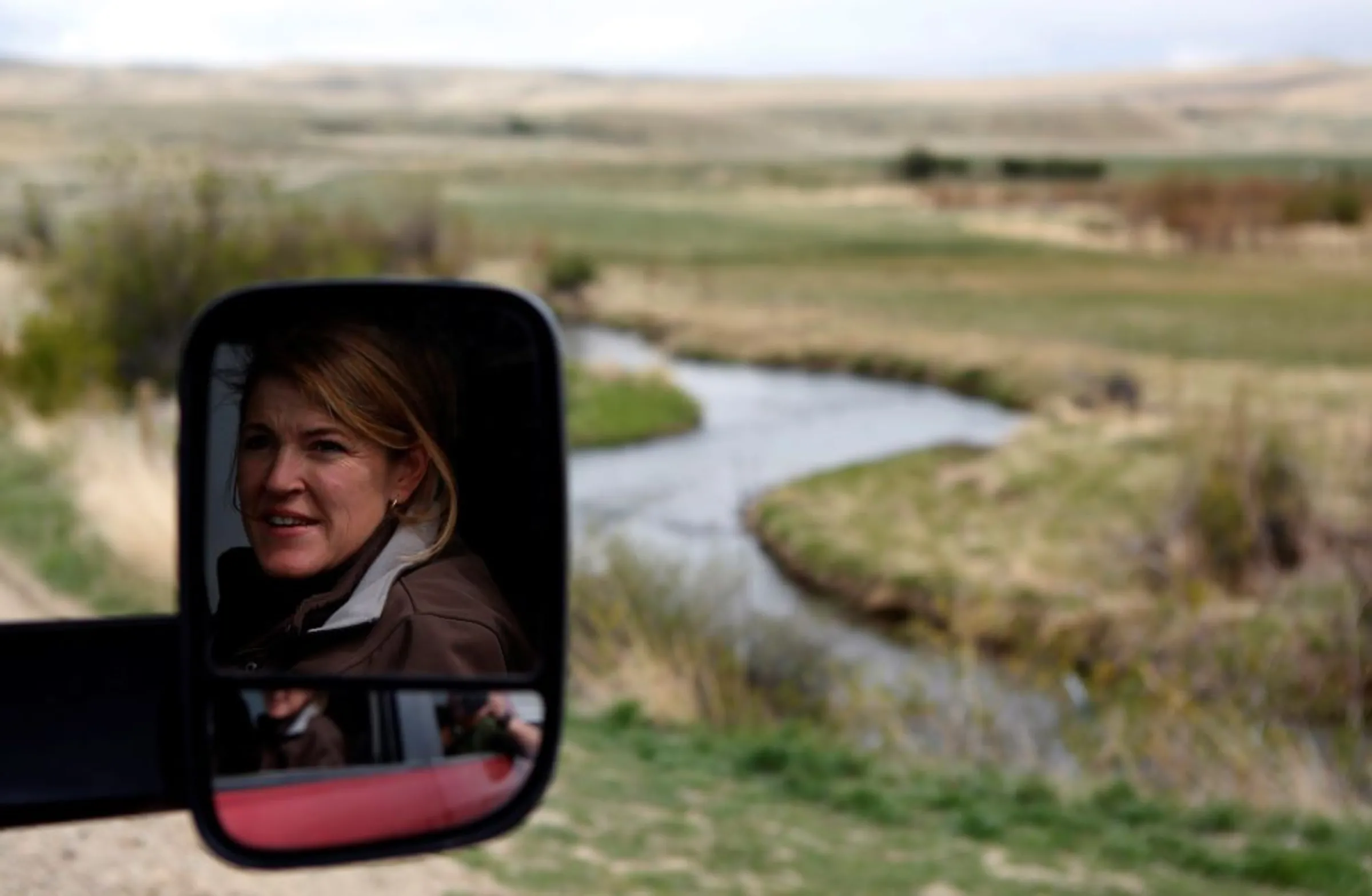 A woman rides in a truck on her way to the wrangler camp before Montana Horses' annual horse drive outside Three Forks, Montana, May 3, 2012.  REUTERS/Jim Urquhart