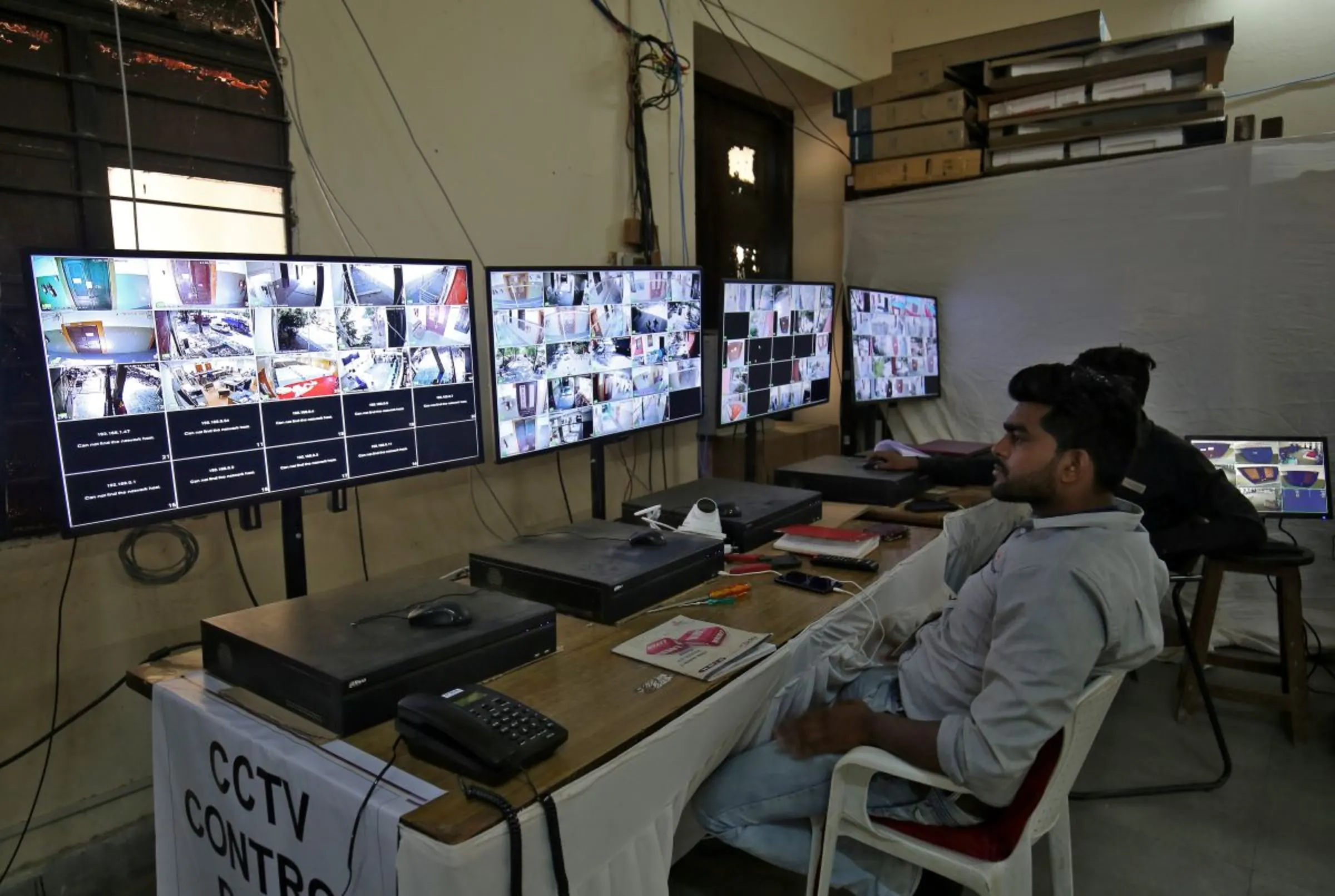 Election staff members monitor screens connected to CCTV cameras set up in and outside vote counting centres in Ahmedabad, India, May 21, 2019