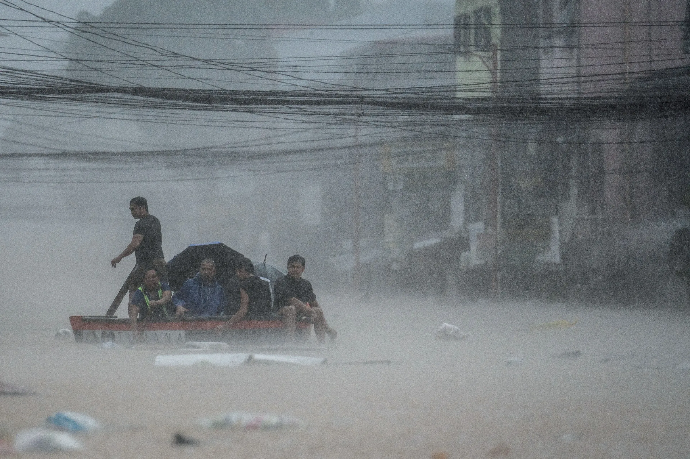 Rescuers assist residents on a boat along a flooded road following heavy rains brought by Typhoon Gaemi, in Marikina City, Metro Manila, Philippines, July 24, 2024. REUTERS/Lisa Marie David
