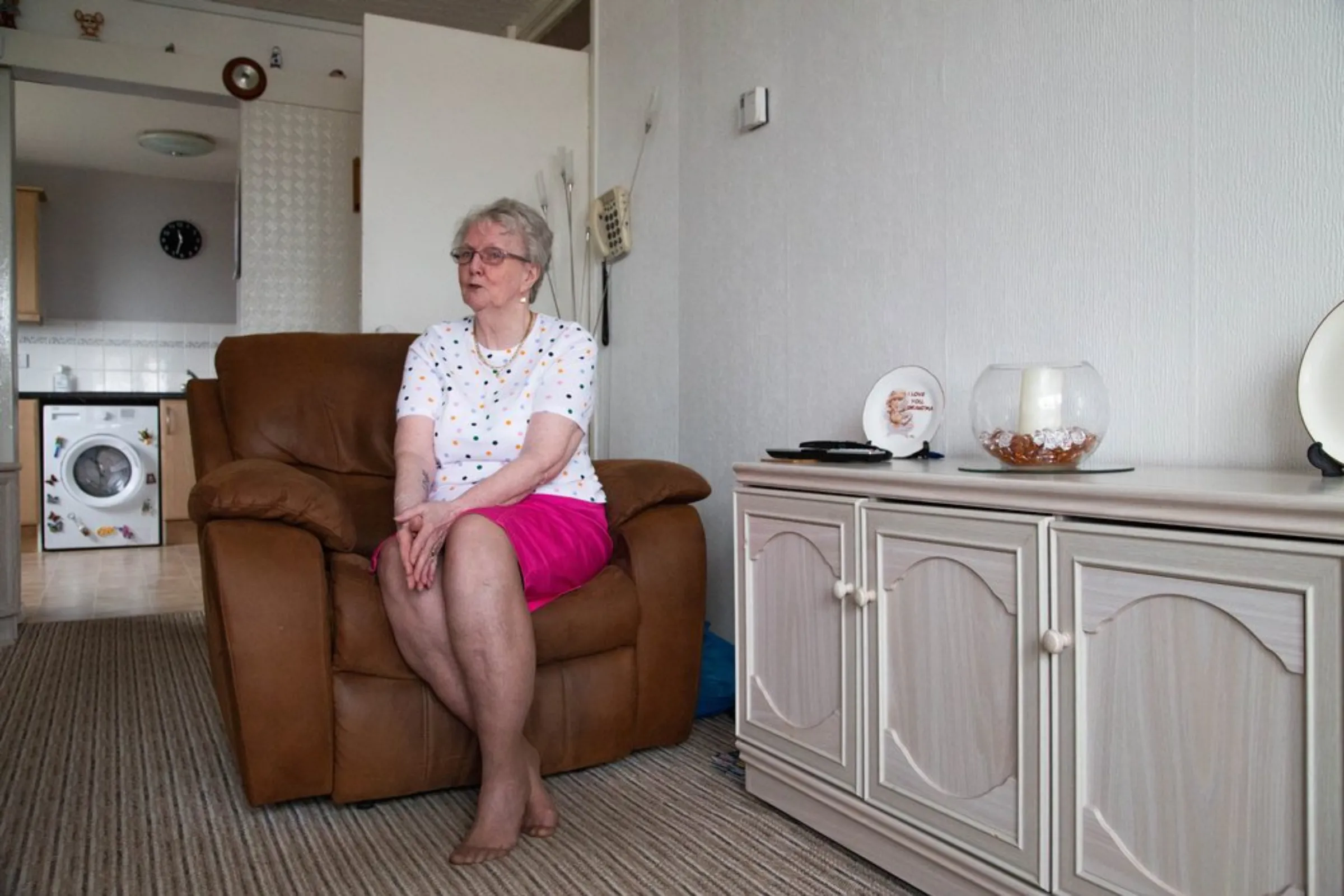 Social housing tenant Margaret Galloway, 77, sits in her home in Glasgow, United Kingdom, July 22, 2021. Galloway said high fuel costs meant some nights she could not afford to cook a full meal before her housing association installed higher-efficiency green energy systems