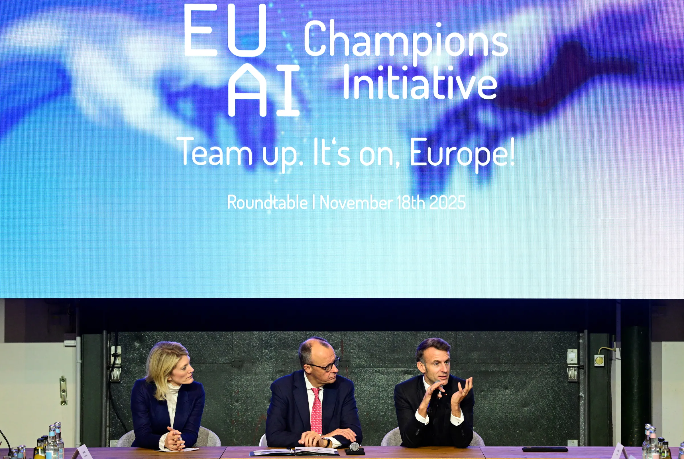 France's President Emmanuel Macron speaks next to German chancellor Friedrich Merz and Managing director and Head of Europe at General Catalyst Jeannette zu Furstenberg at the EU AI Champions Initiative at a summit on Europe's technological sovereignty, in the EUREF Campus in Berlin, Germany, on November 18, 2025. JOHN MACDOUGALL/Pool via REUTERS