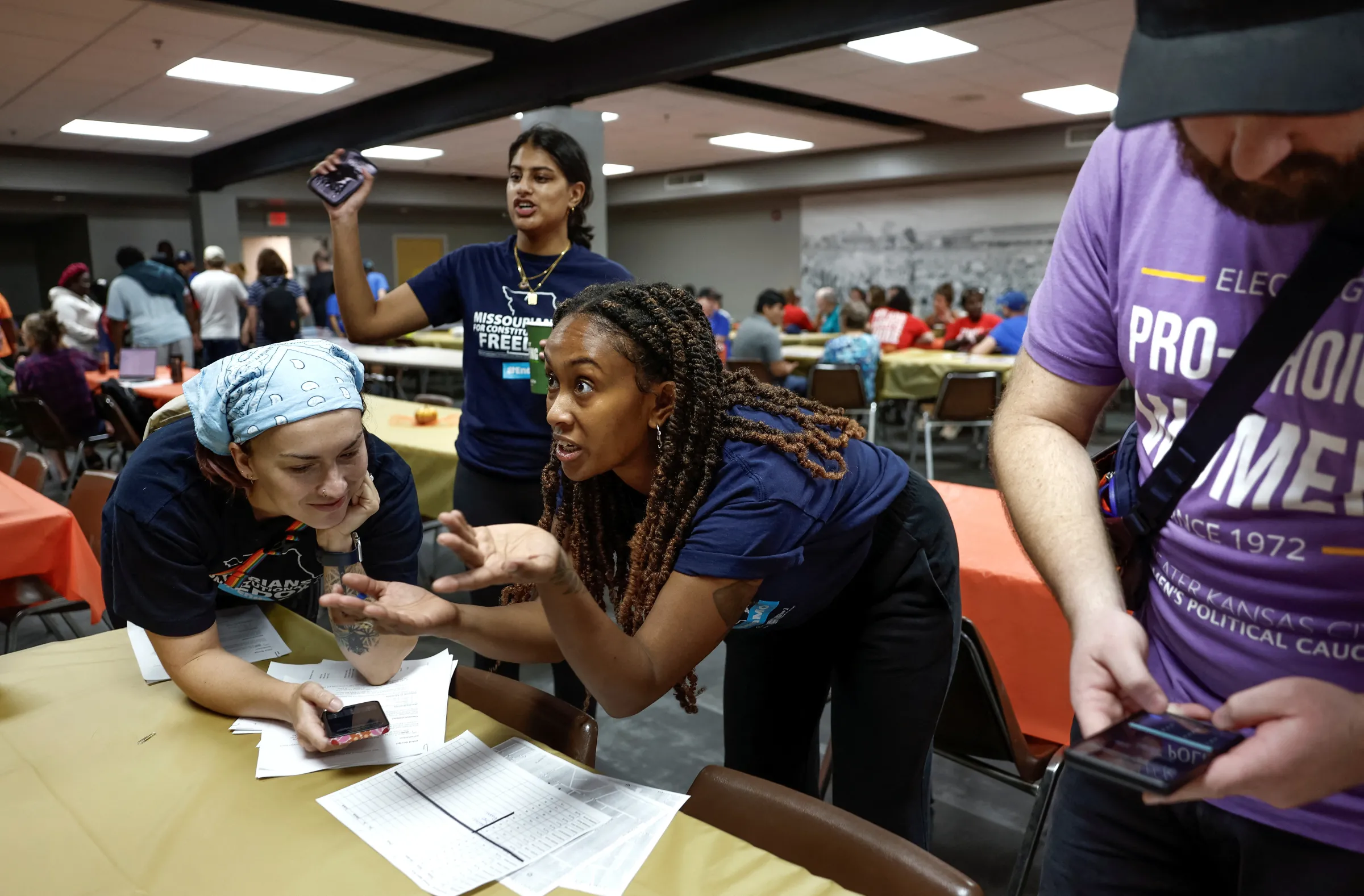 Volunteer canvassers go over their address lists before heading out to knock doors for two Missouri ballot amendments including Amendment 3, a measure that would establish a constitutional right to abortion, in Kansas City, Missouri, U.S., October 12, 2024. REUTERS/Evelyn Hockstein