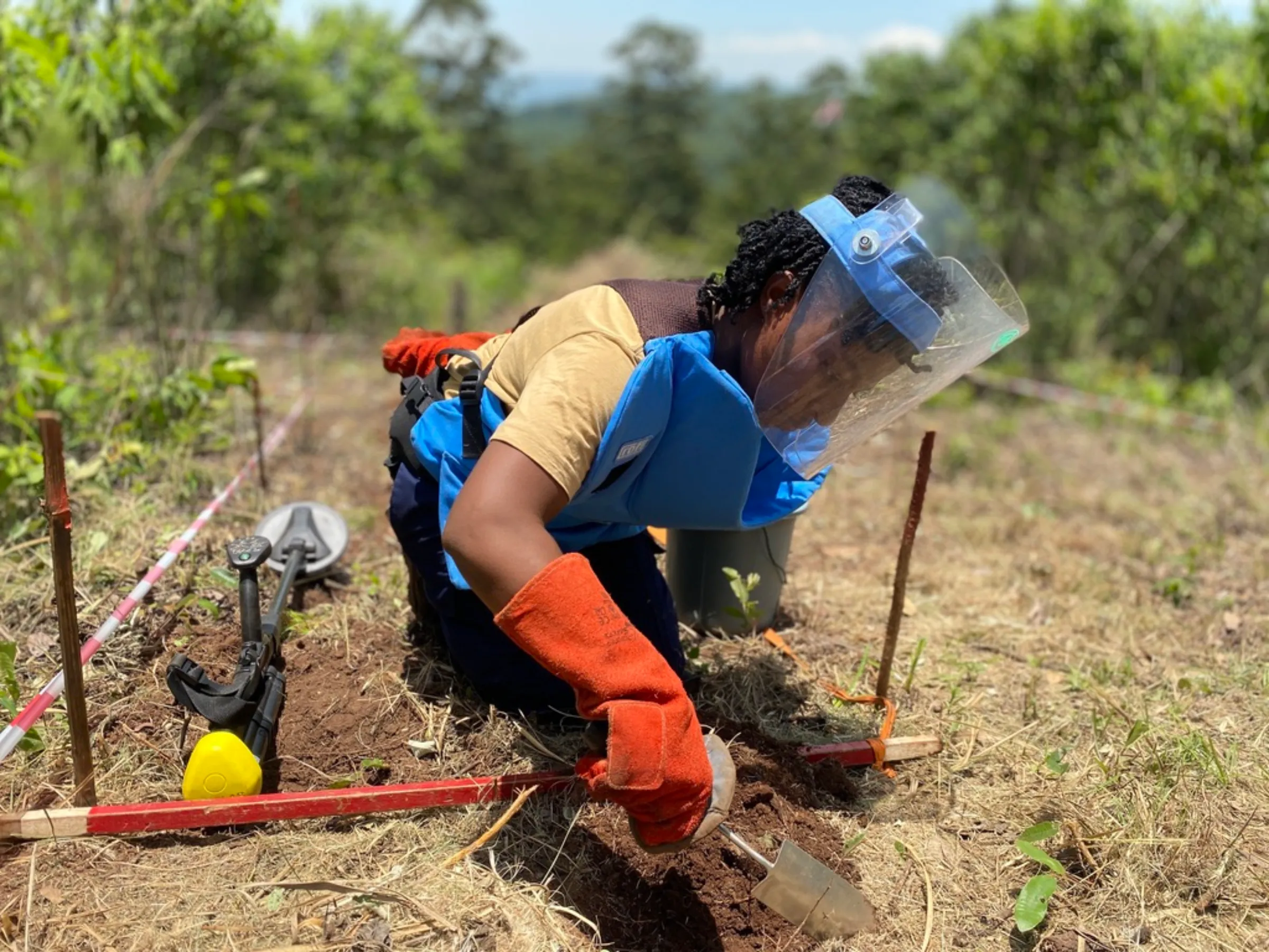 Moreblessing Makukunzva, a female deminer removing scrap metal in Chipinge, Zimbabwe, December 16, 2022. Thomson Reuters Foundation/Farai Shawn Matiashe