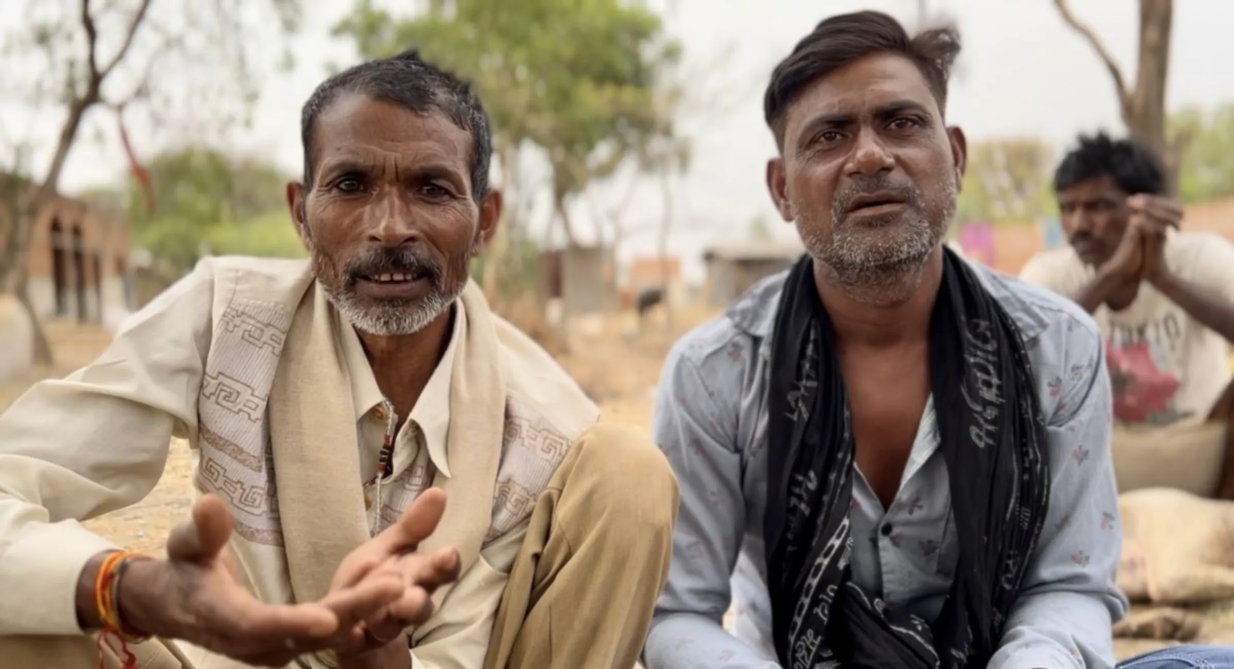 Migrant construction labourers Ram Kishor (left) and Manoj Kumar (right) are shown sitting together in Banda, India, May 15, 2024. Thomson Reuters Foundation/Bhasker Tripathi