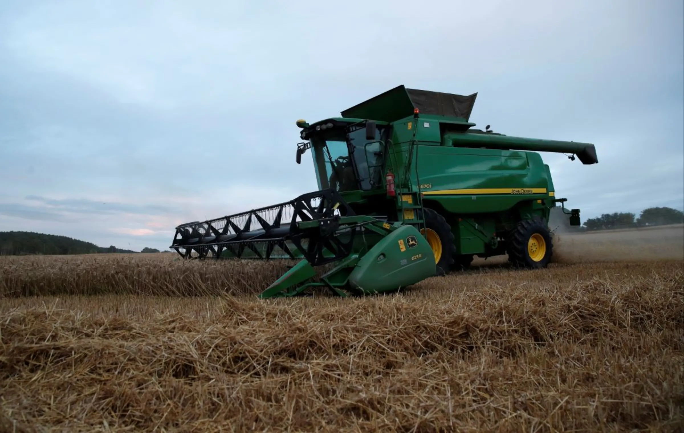 A combine harvester is seen harvesting winter wheat in a field near Kimpton, Britain, August 5, 2020. Picture taken August 5, 2020. REUTERS/Peter Cziborra