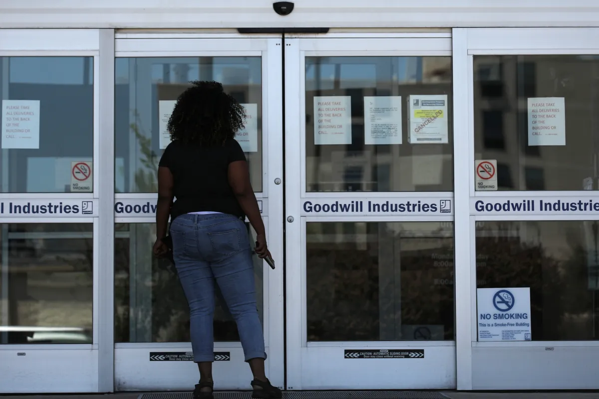 A woman looks for information on the application for unemployment support at the New Orleans Office of Workforce Development