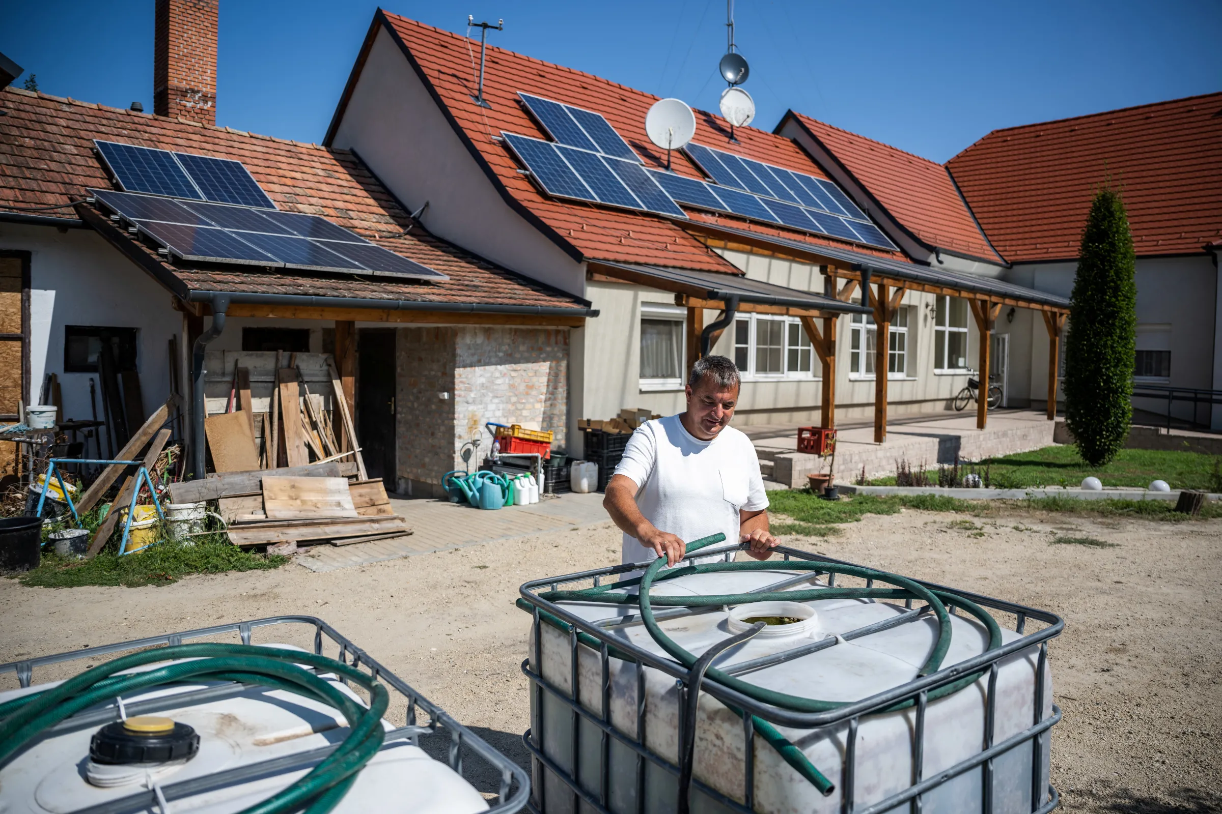 Mayor Volfinger Bela checks the water level in rainwater collection tanks in Papateszer, Hungary, August 23, 2024. REUTERS/Marton Monus