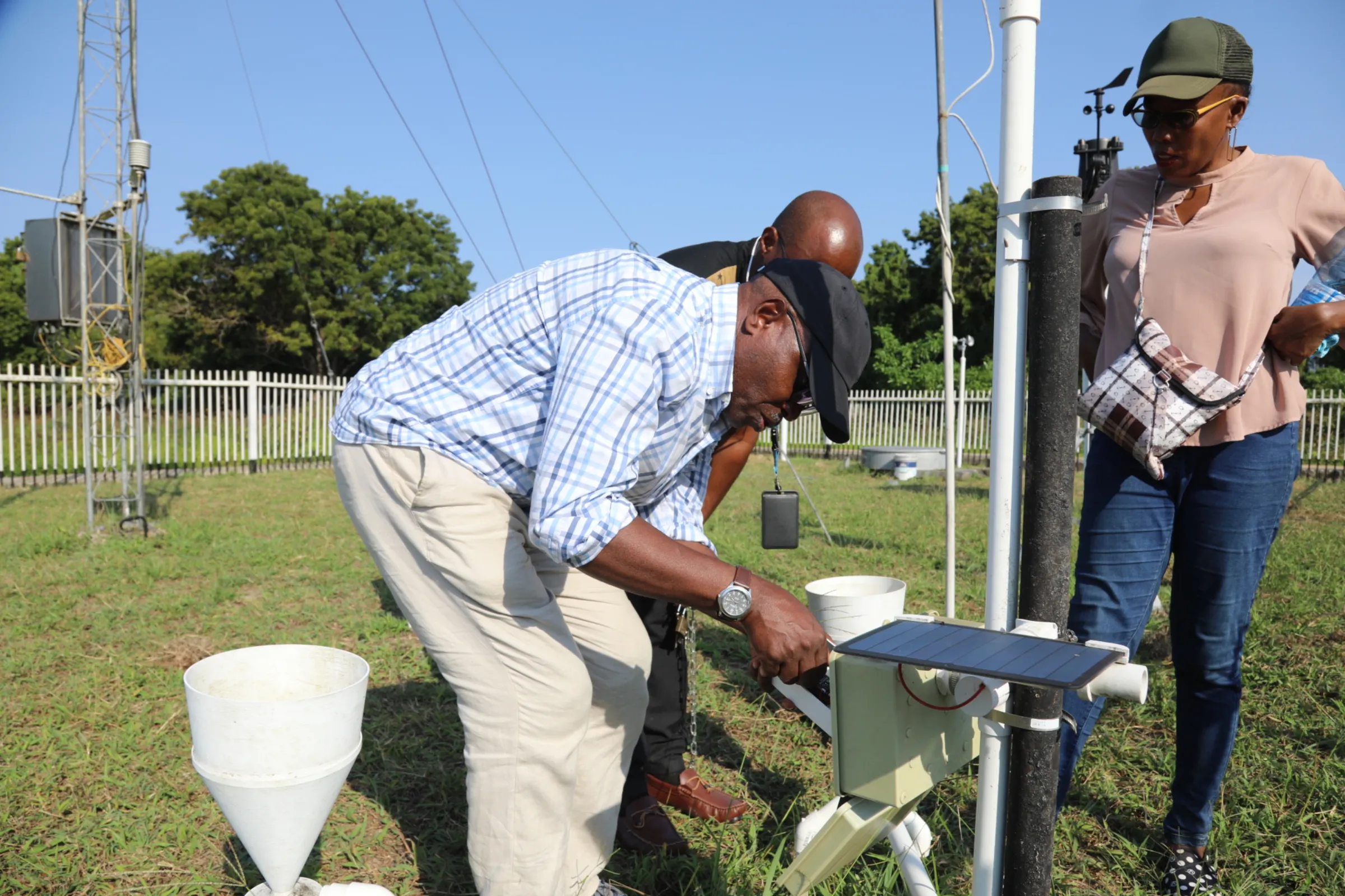 FEWS Net and Kenyan officials inspecting an automatic, 3D-printed weather station in Kilifi County, August 5, 2024. Thomson Reuters Foundation/Peter Yeung